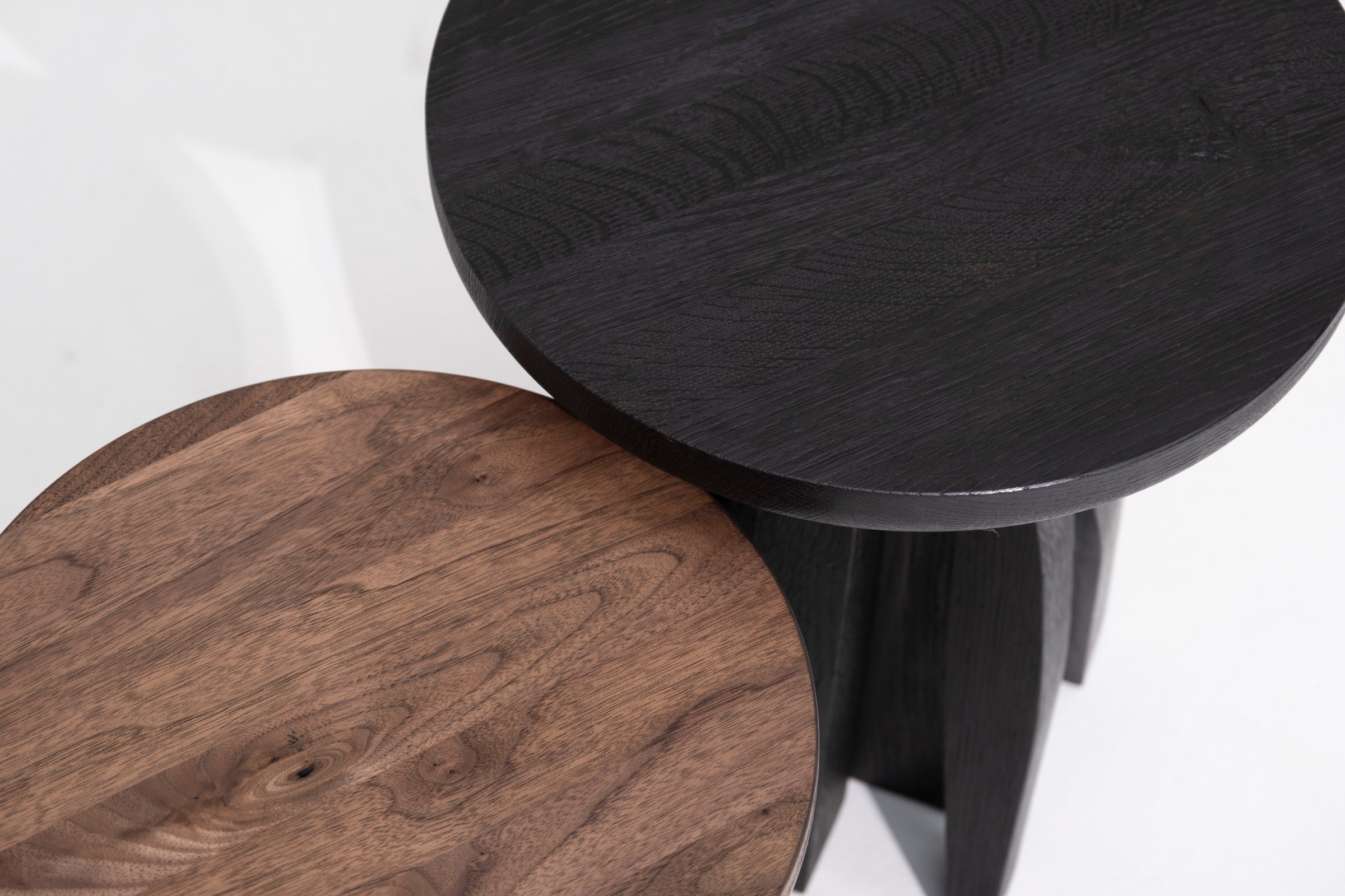Close-up of the black oak and natural American walnut tops of the Umbo Side Tables by Arno Declercq.