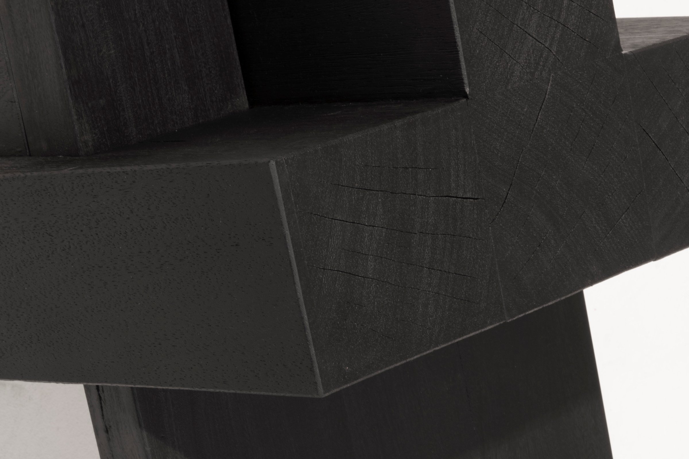Close-up of the carved Iroko joint of the AD Bench 2.0 by Arno Declercq.