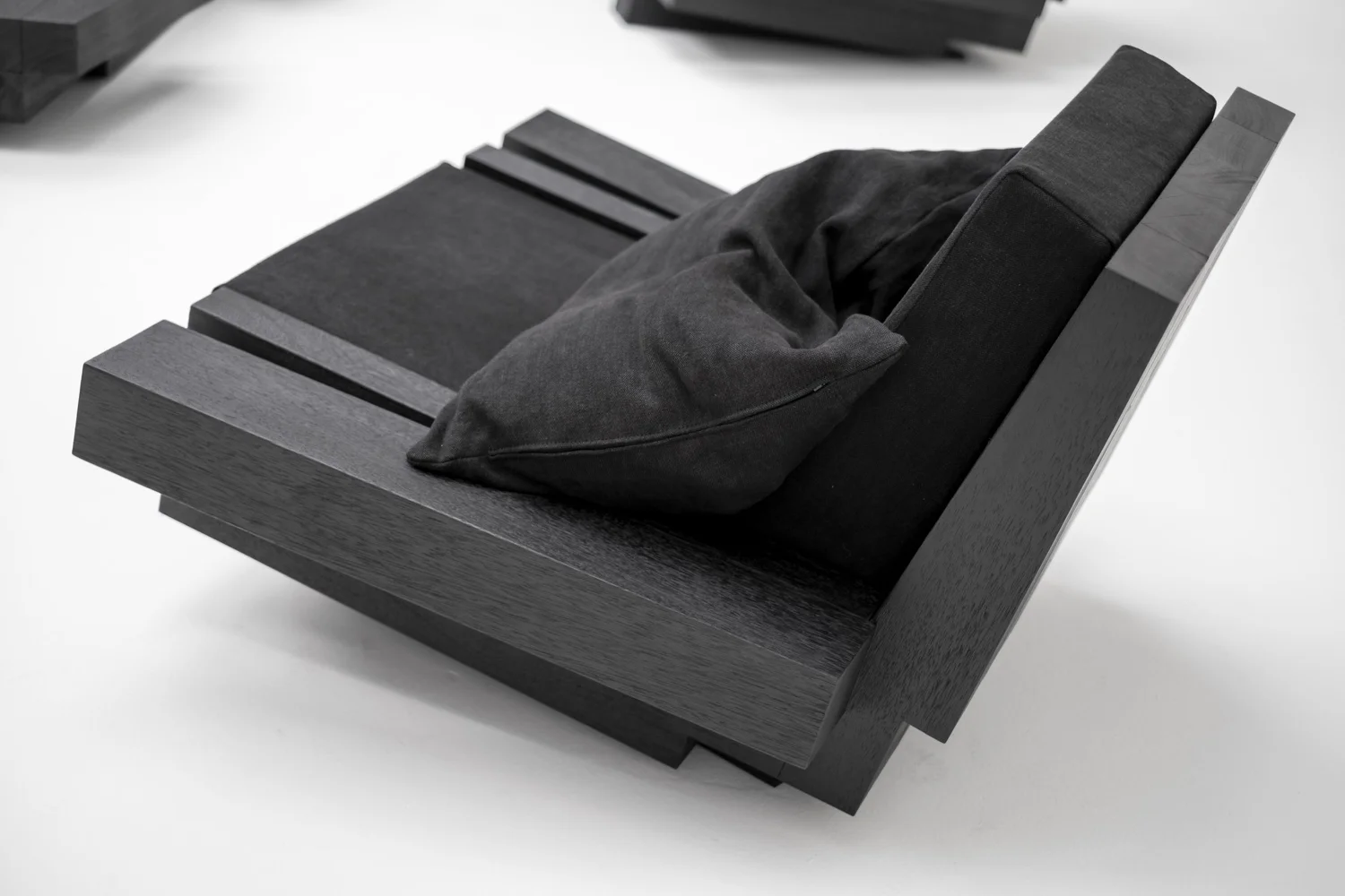 Detail of the burned Iroko structure of Zoumey Lounge Chair 012024 by Arno Declercq.