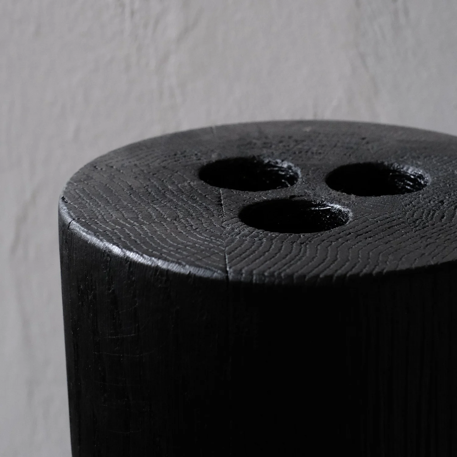Close-up of the drilled openings and burned oak grain of the Babel Vase by Arno Declercq.