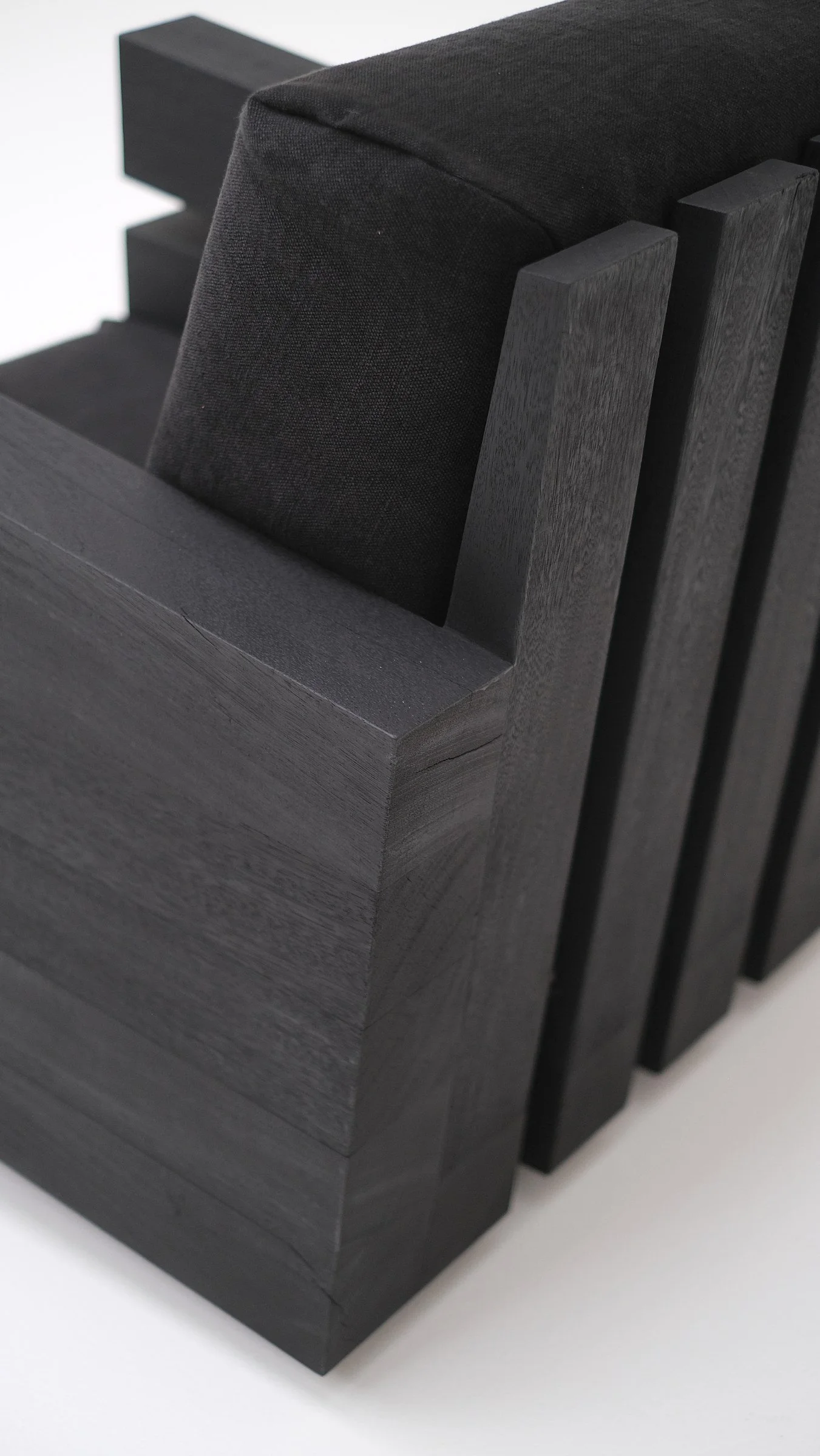 Detail of the layered burned Iroko wood of Zoumey Armchair 102023 by Arno Declercq.