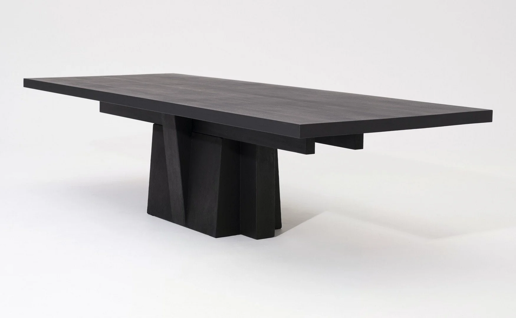 Dining Table 032025 by Arno Declercq in burned and oiled afrormosia with a burned steel base, photographed against a neutral studio background.