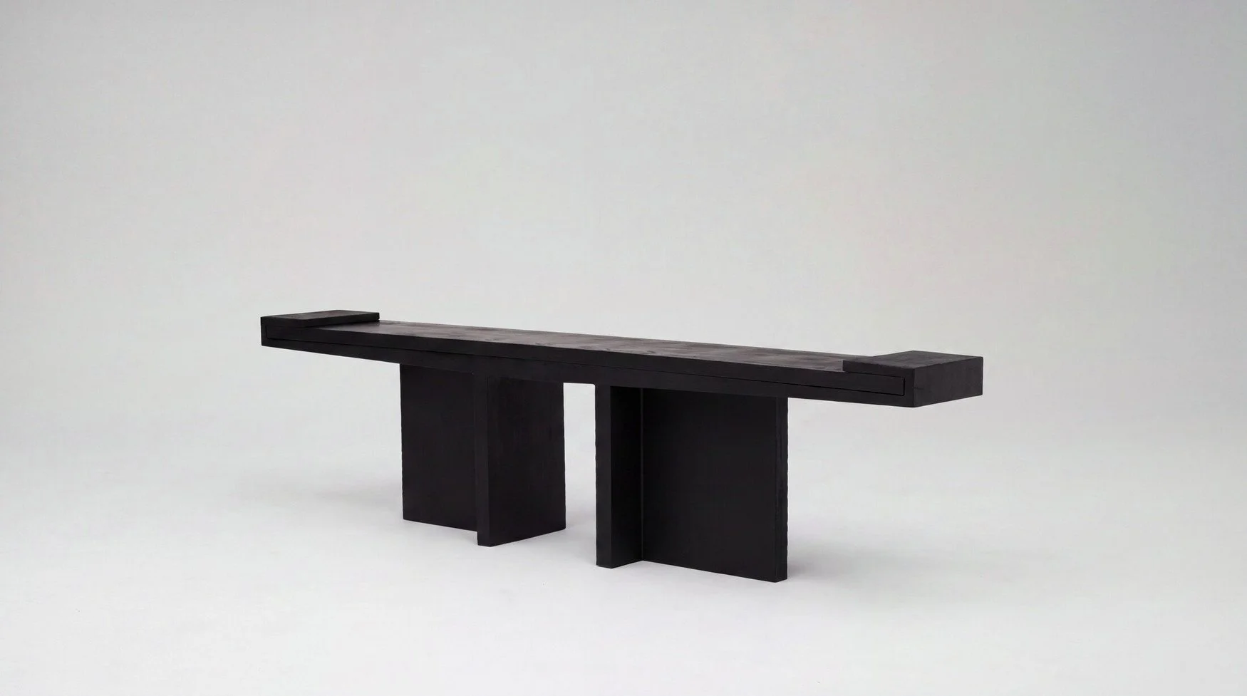 Console 102024 by Arno Declercq in burned and oiled oak and burned steel, photographed against a neutral grey studio background.