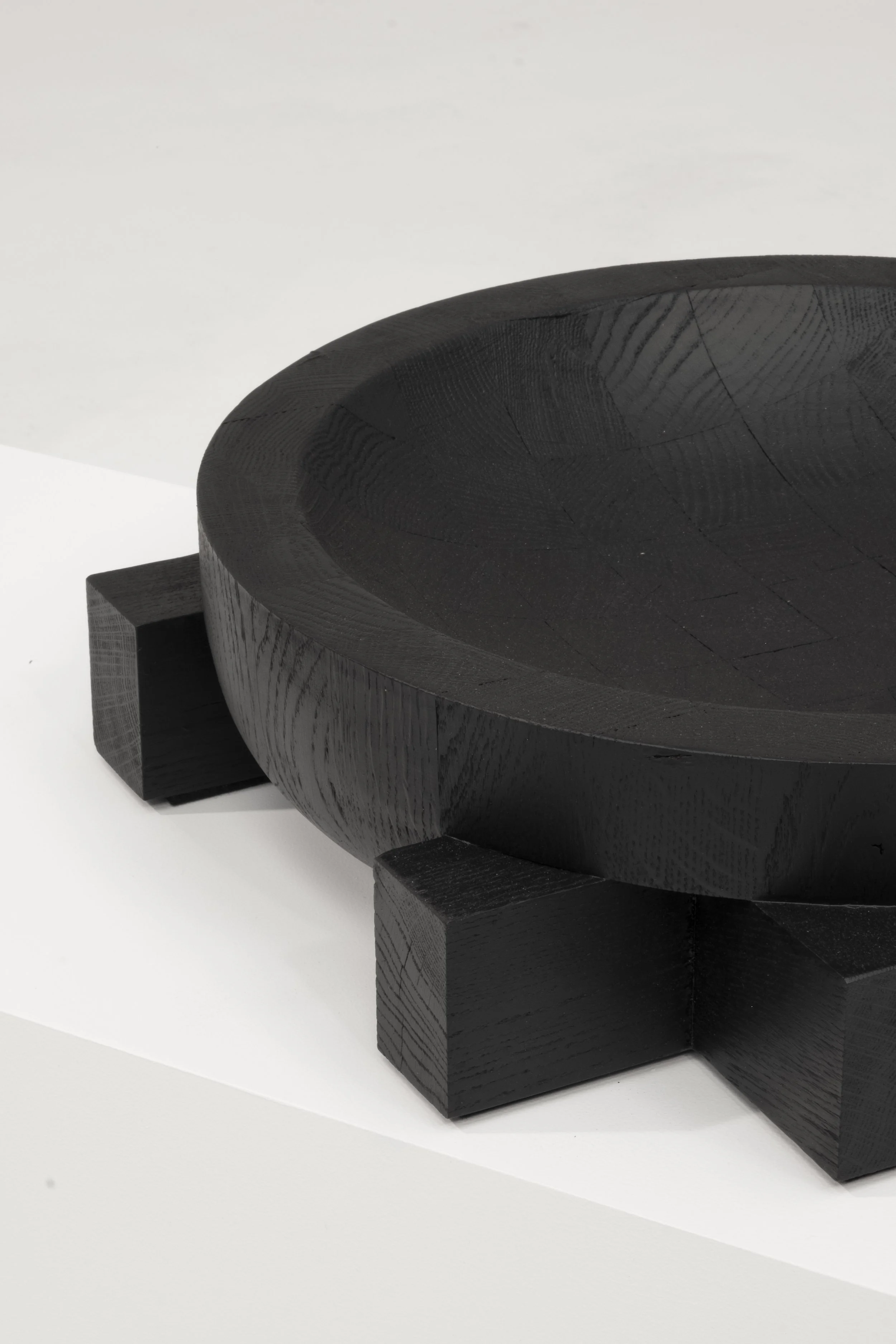Detail of the carved oak rim and cross-shaped support of the Cross Tray by Arno Declercq.