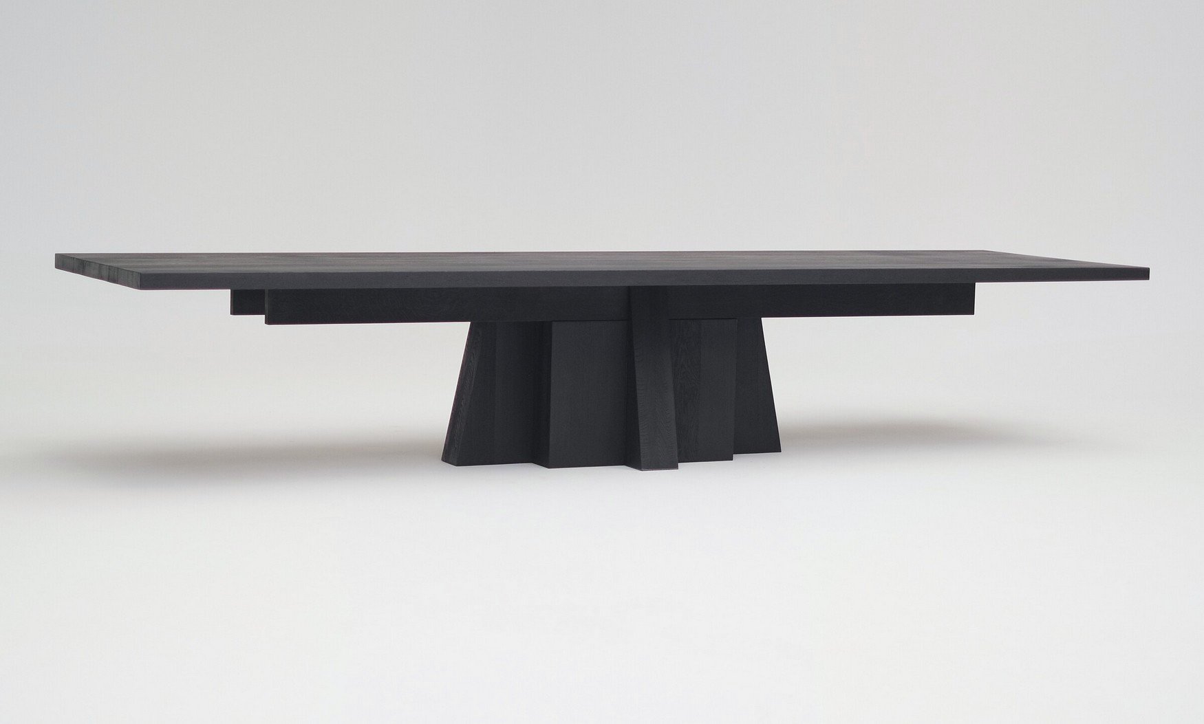 Dining Table 032023 by Arno Declercq in burned and oiled oak, with the full table visible against a neutral studio background.