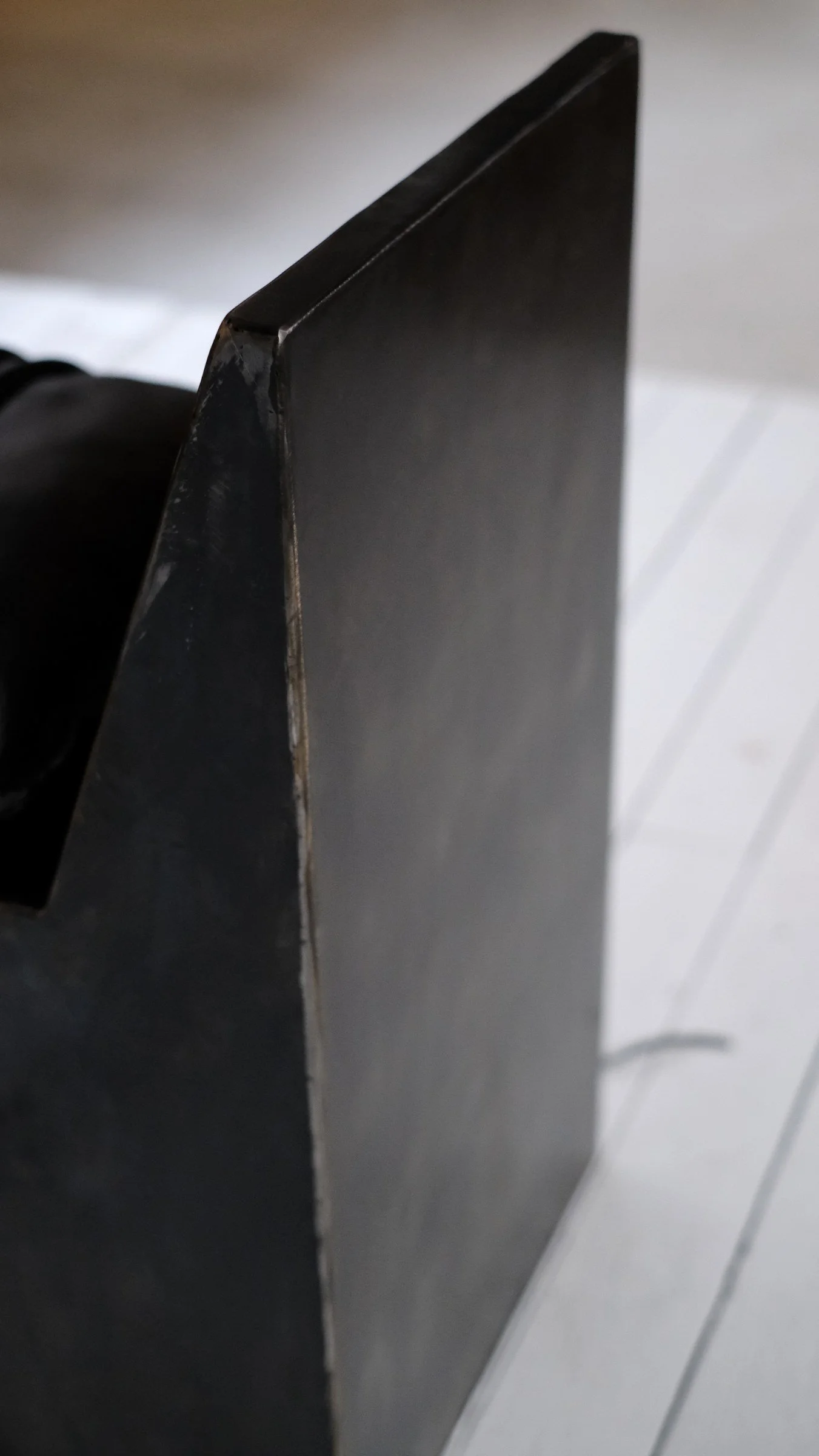 Detail of the patinated metal edge of the AD Stool 2.0 by Arno Declercq.