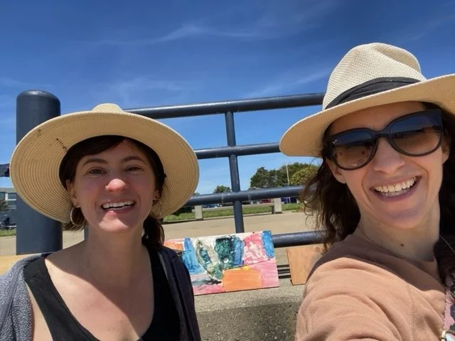 Ariella Cook-Shonkoff with artist Patricia Trix Adler after their Earth Day recycled art activity