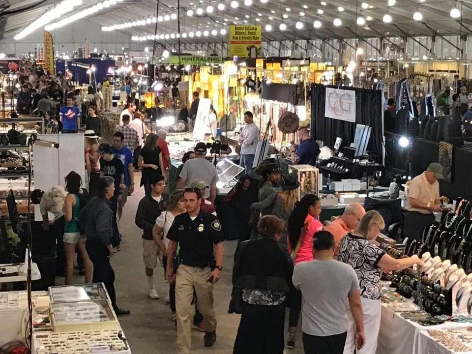 Vendor booths and attendees at the Tucson Gem Show in Tucson, Arizona.