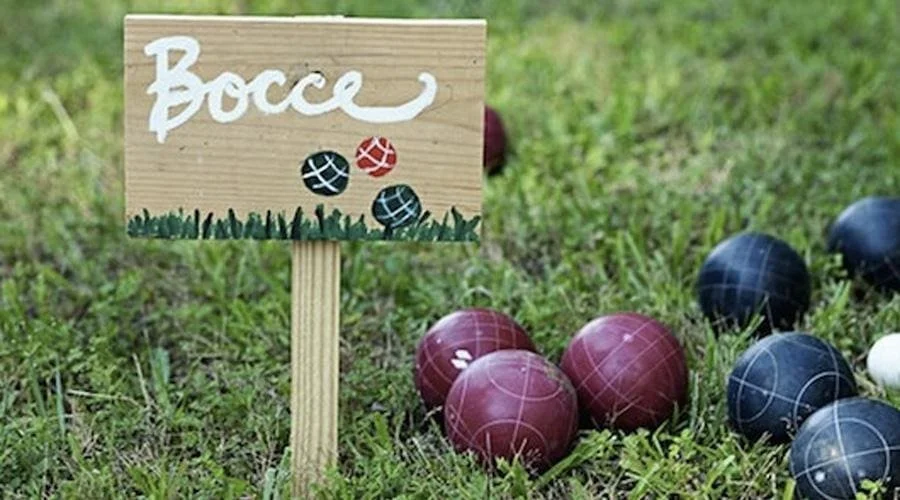 Bocce balls and tournament sign promoting The SOAP Project's Bocce Tournament to Stop Trafficking fundraiser in Westerville, Ohio.