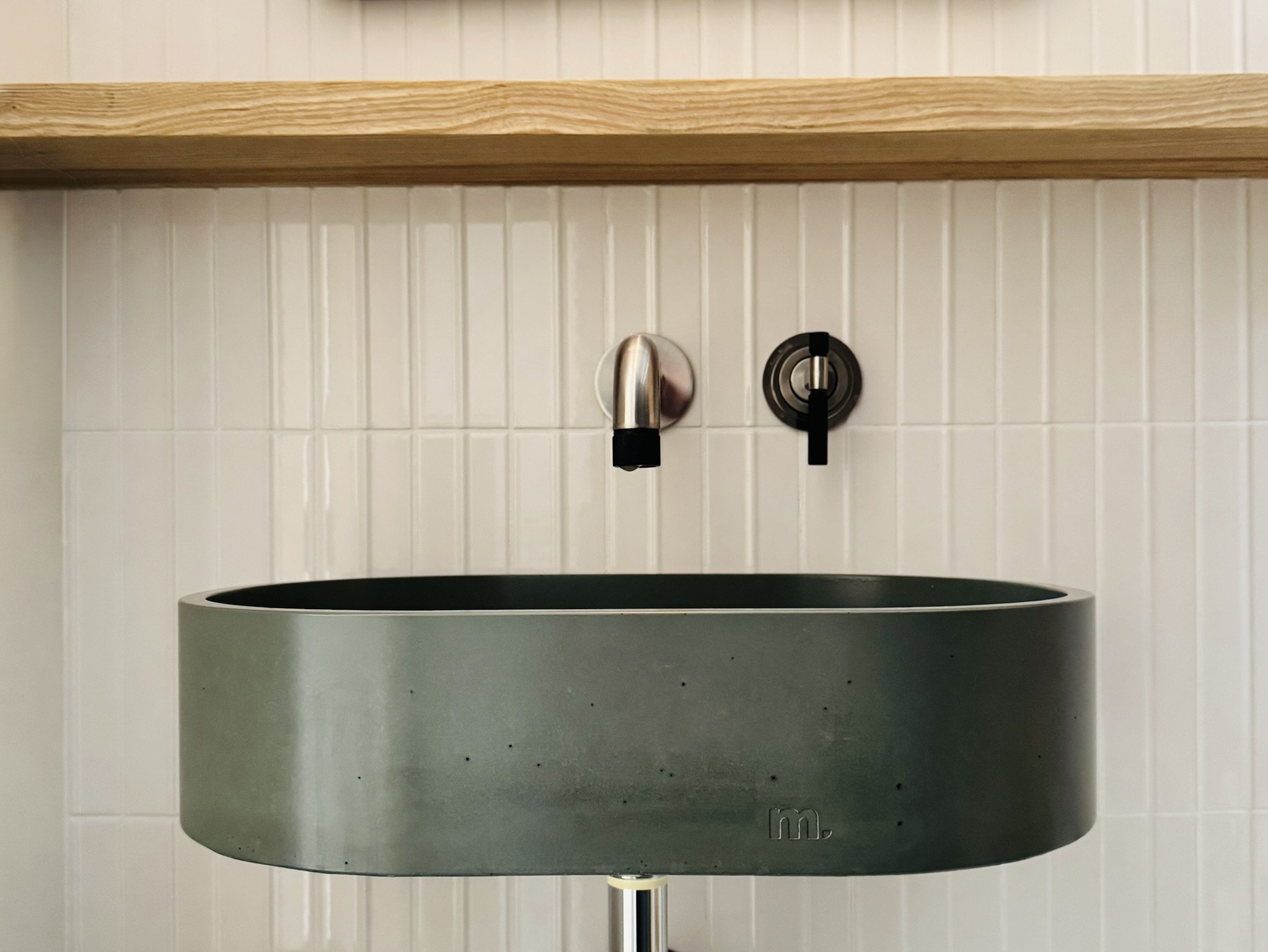 Accessible bathroom at Hinterhaus 41 by Elevin Design Studio featuring ash tongue and groove walls, white Scandinavian tile, and a green Mudd concrete freestanding oval sink, contemporary residential interior, photo by Brad and Shawn Hernden