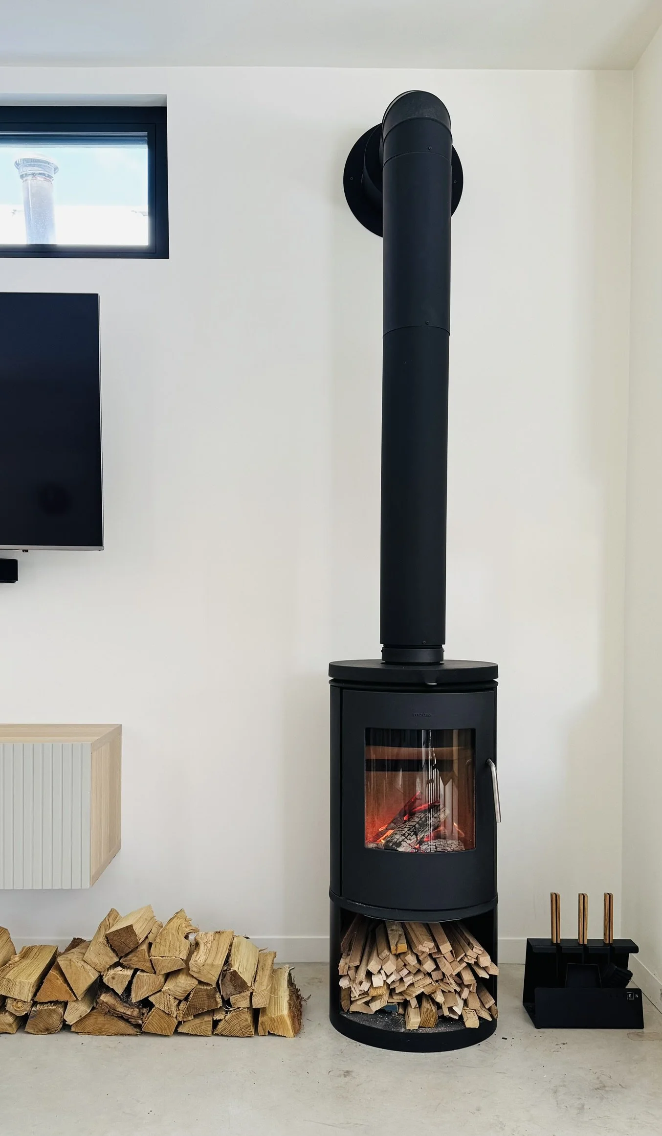 Black Morso 6143 wood burning fireplace from Denmark at Hinterhaus 41 by Elevin Design Studio, modern Scandinavian interior feature, photo by Brad and Shawn Hernden