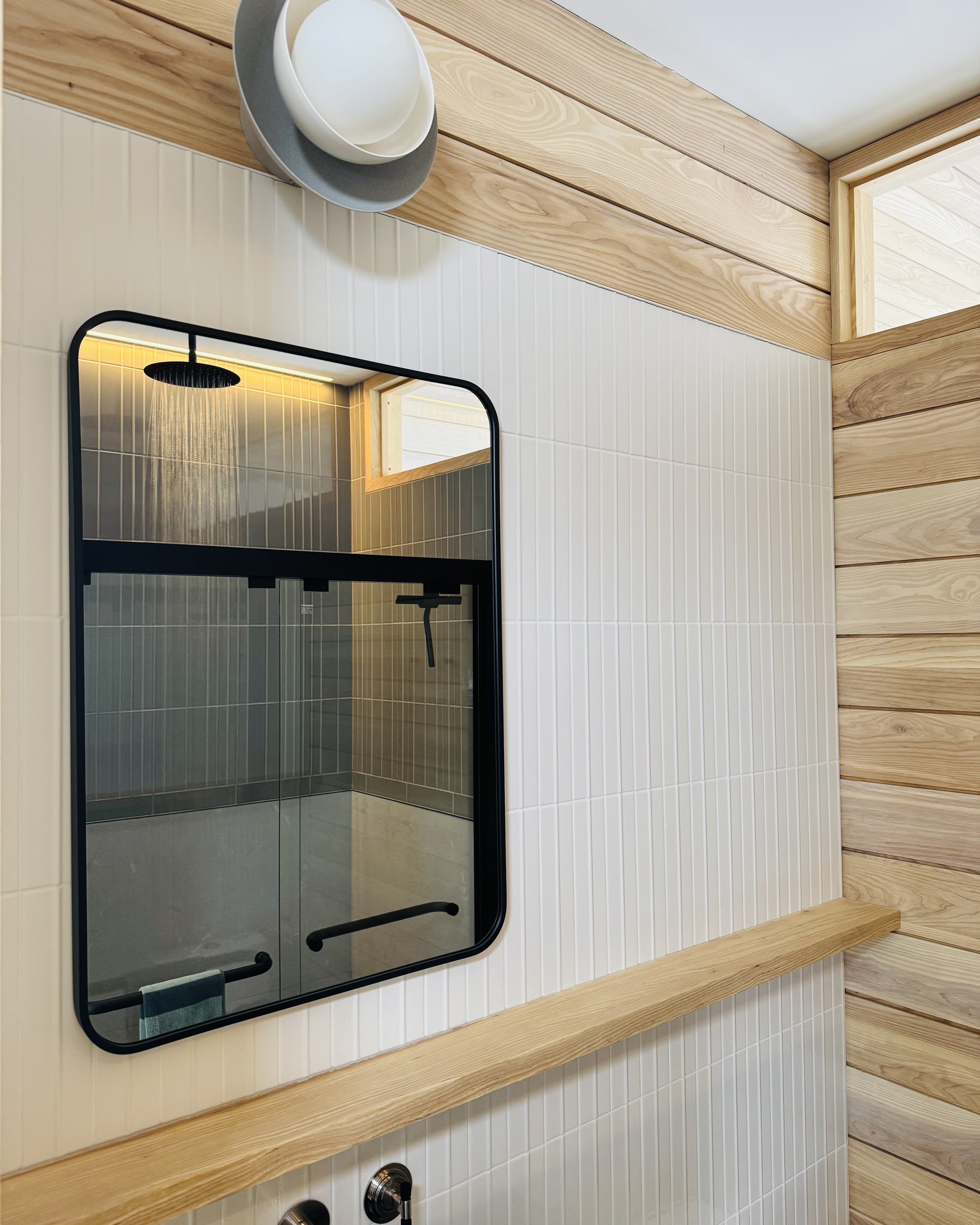 HH29-hinterhaus-41-nordic-barn-adu-elevin-design-group-bathroom-mirror-shower-detail-ash-wood-floating-ledge.jpg