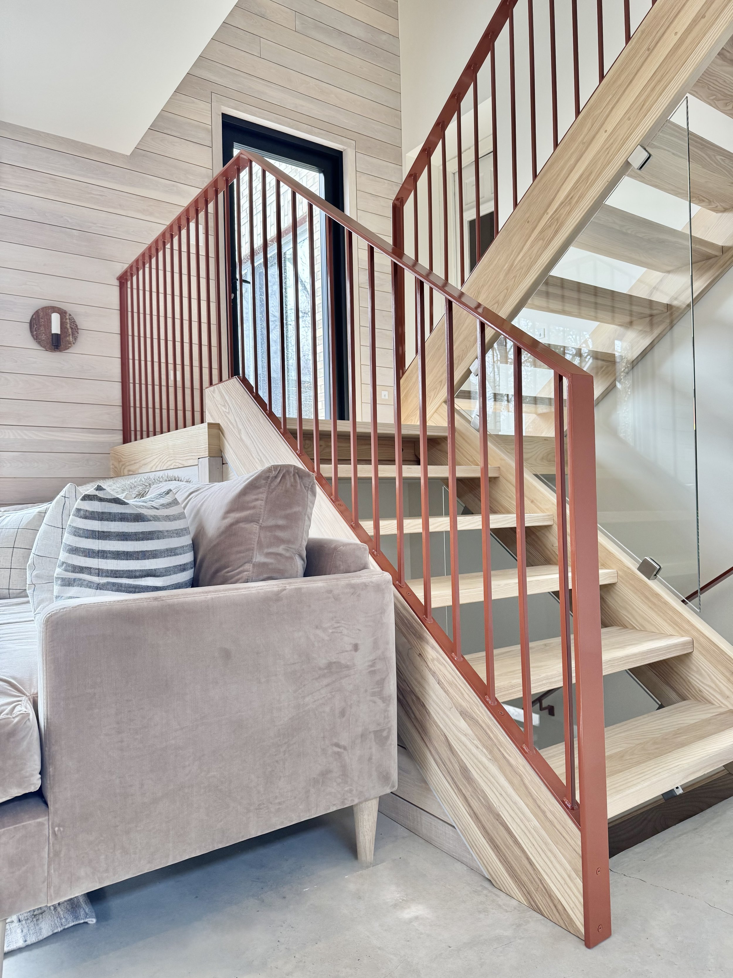 HH52-hinterhaus-41-stratford-ontario-open-stair-risers-rust-iron-railings-nordic-interiors-scandinavian-accessory-dwelling-unit-wills-and-prior-stratford-sectional-couch-with-earthy-velvet.jpeg