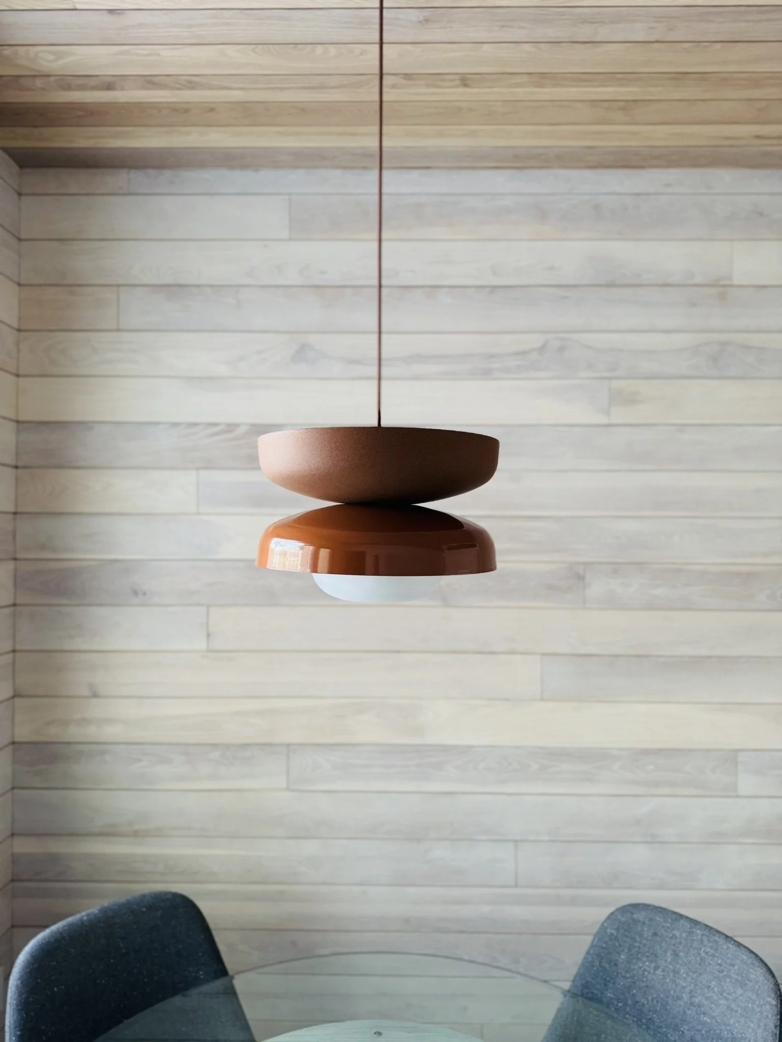 Two-toned rust coloured pendant light by Luminaire Authentik Quebec at Hinterhaus 41 by Elevin Design Studio, modern interior lighting detail, photo by Brad and Shawn Hernden