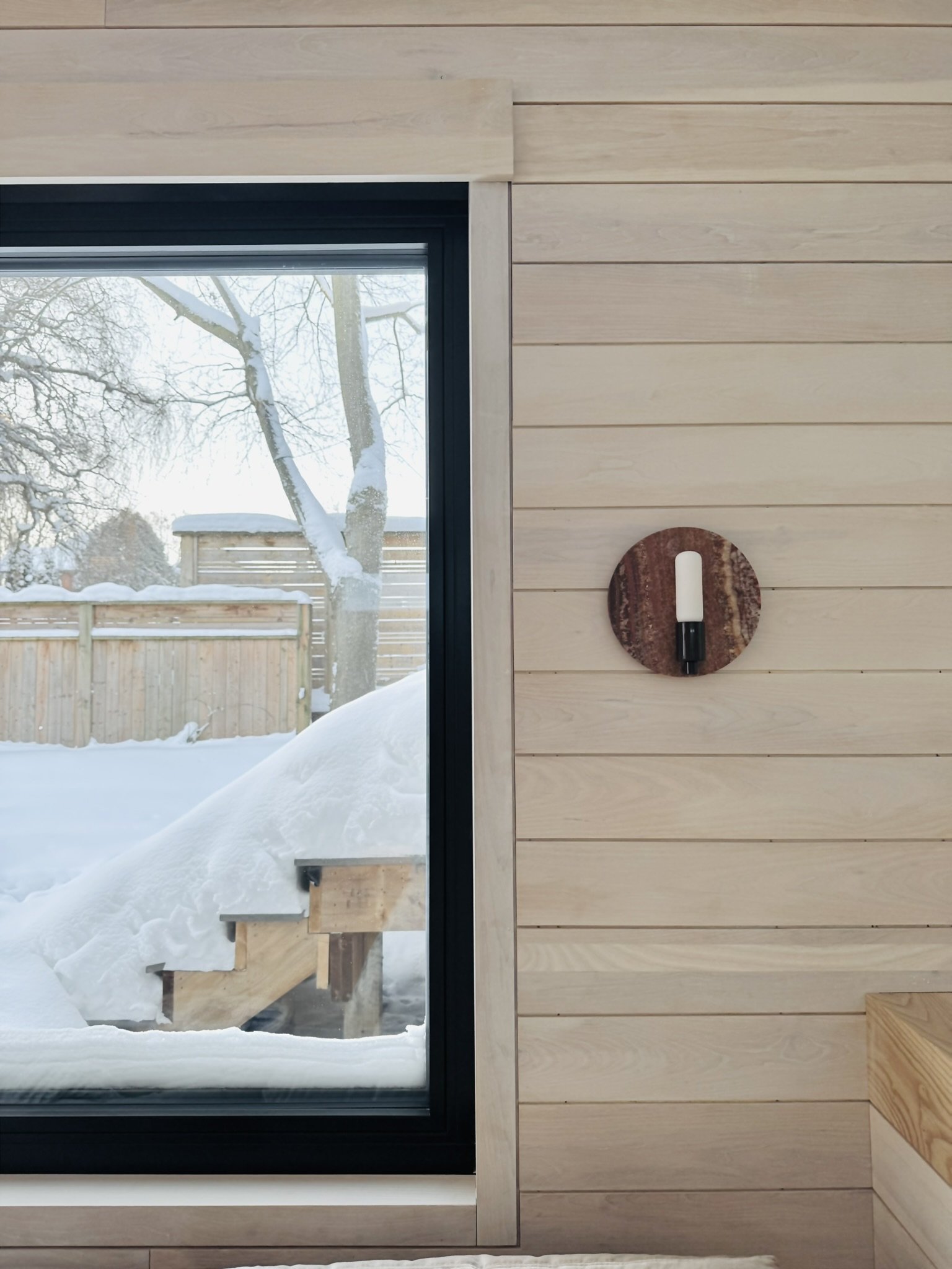 Stone Eclipse wall sconce in Onyx Rust by Luminaire Authentik Quebec at Hinterhaus 41 by Elevin Design Studio, modern architectural lighting detail, photo by Brad and Shawn Hernden