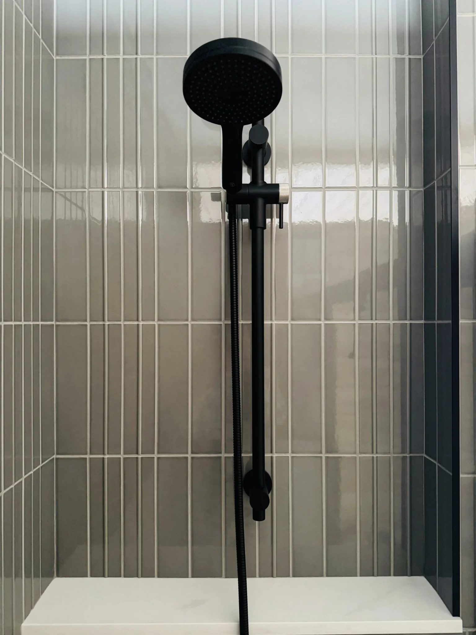 Accessible bathroom at Hinterhaus 41 by Elevin Design Studio featuring grey-green Scandinavian subway tile and fixtures by Tenzo Quebec Canada, modern residential interior, photo by Brad and Shawn Hernden