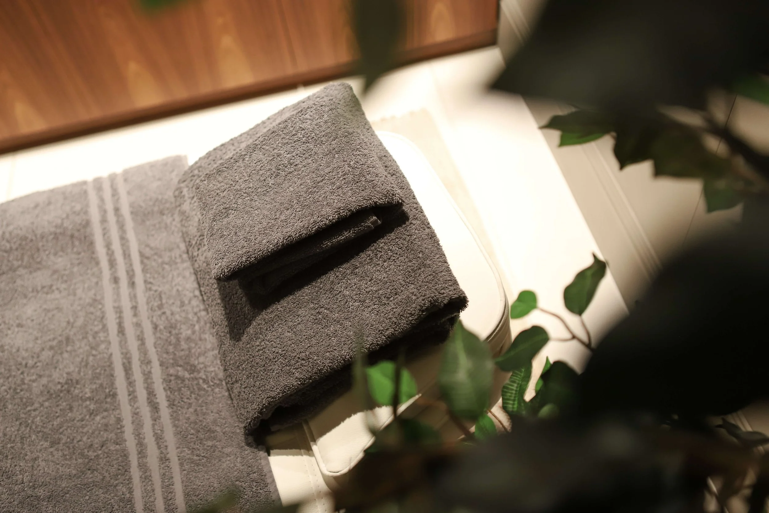 Neatly laid out towels on comfy massage therapy bed