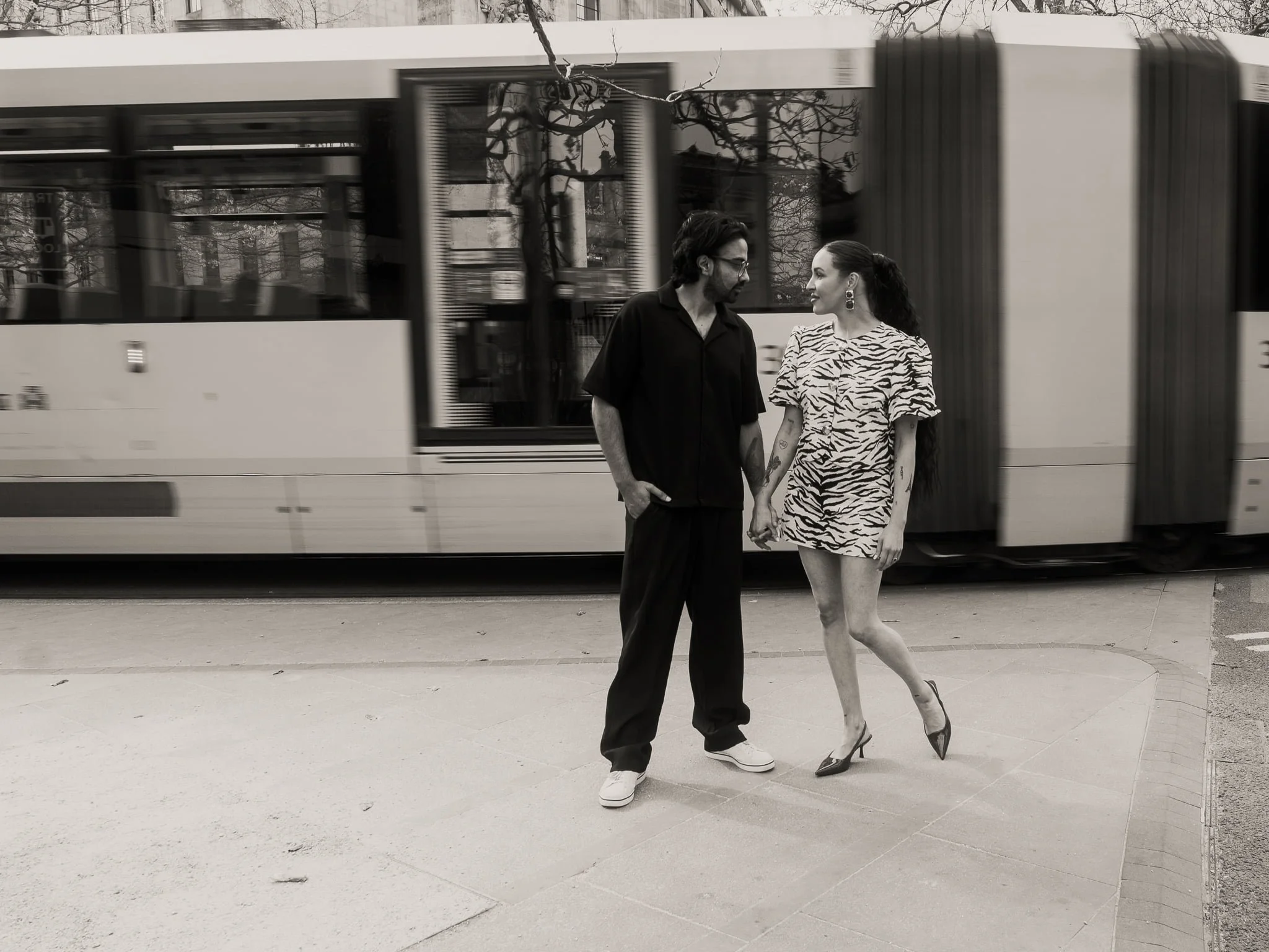 Engaged couple holding hands in Manchester city centre  