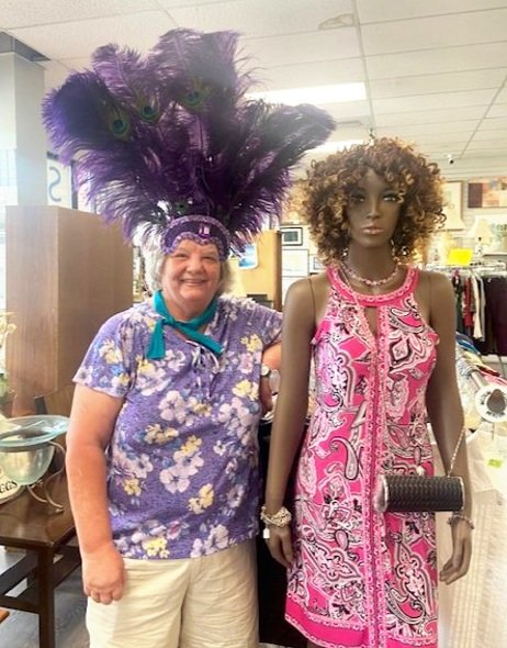 Sometimes it takes a real life volunteer to model a treasure. Susie shows off this fabulous purple feather headdress.