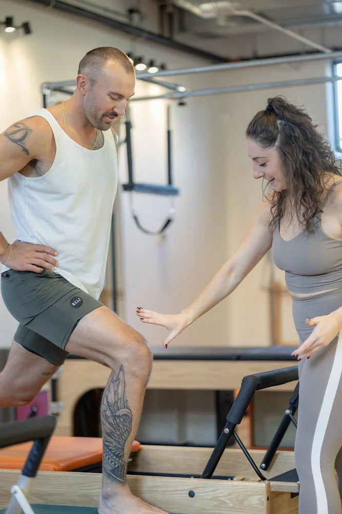 Head chef Katie assists a private client post ACL surgery on the reformer in RINo.