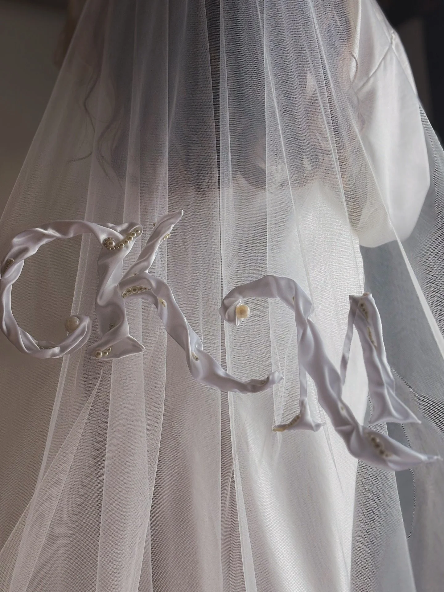 Customisable Couture Veils. 
What are your initials? 
Hand embroidered in flowing silk ribbon is the bridal couples initials, scattered with pearls between the folds of silk. 
The perfect veil for brides with a simpler dress, but want a moment that&r