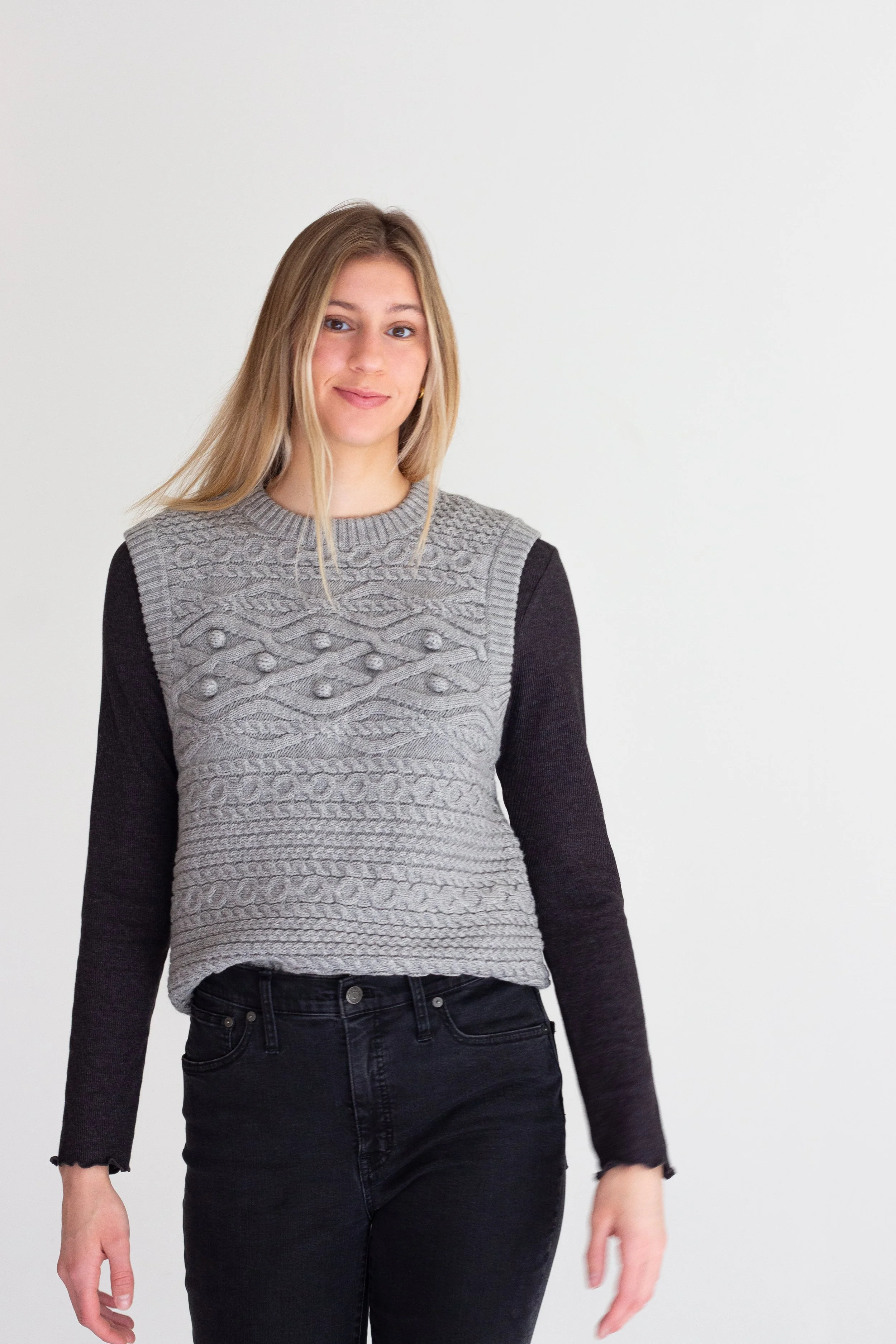 Model Grace Cleveland Purdue University Volleyball player number # 20 Big Ten, All American, AVCA. Was a summer intern at HTHR internship. She is modeling a gray sweater vest made exclusively at HTHR