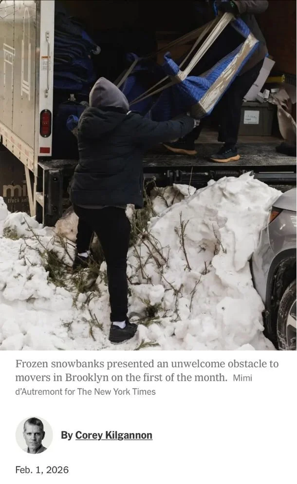 nyc moving team loading a truck parked at a snowbank