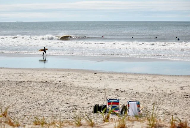 surfers in the water at Rockaway Beach in Queens