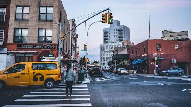a woman crossing the street in Long Island City, Queens, New York
