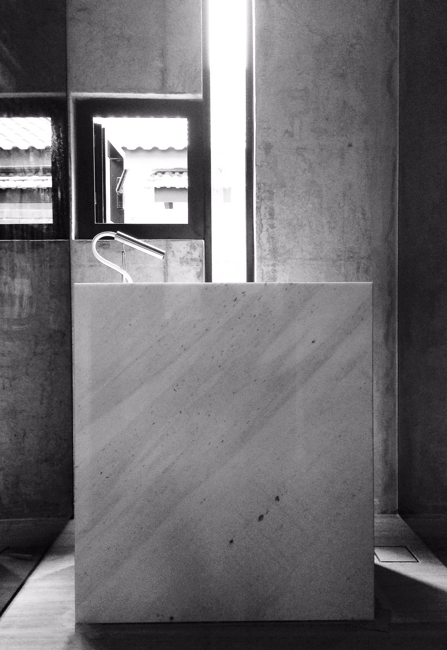 Custom marble vanity with the signature 'microphone' tap turns an everyday function into a dramatic affair.