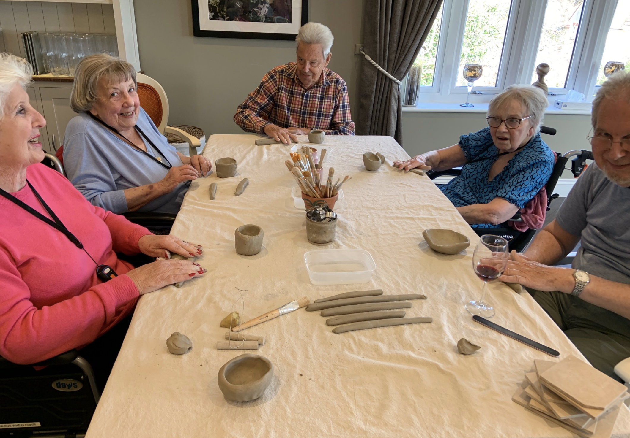 Participants enjoying a creative pottery activity at a residential care home.