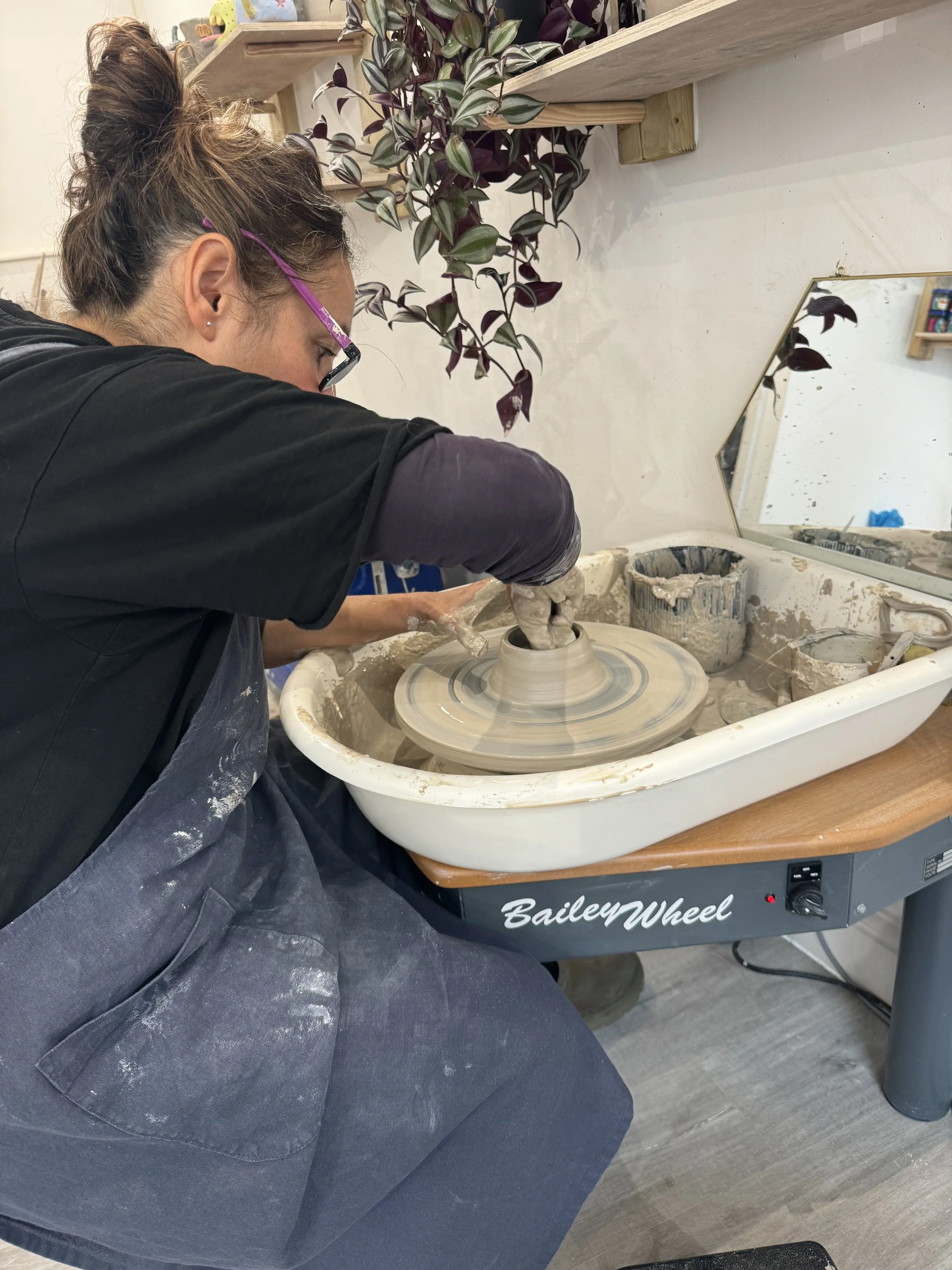 shaping clay on pottery wheels during a beginners’ class at Clod Pots, Exmouth.