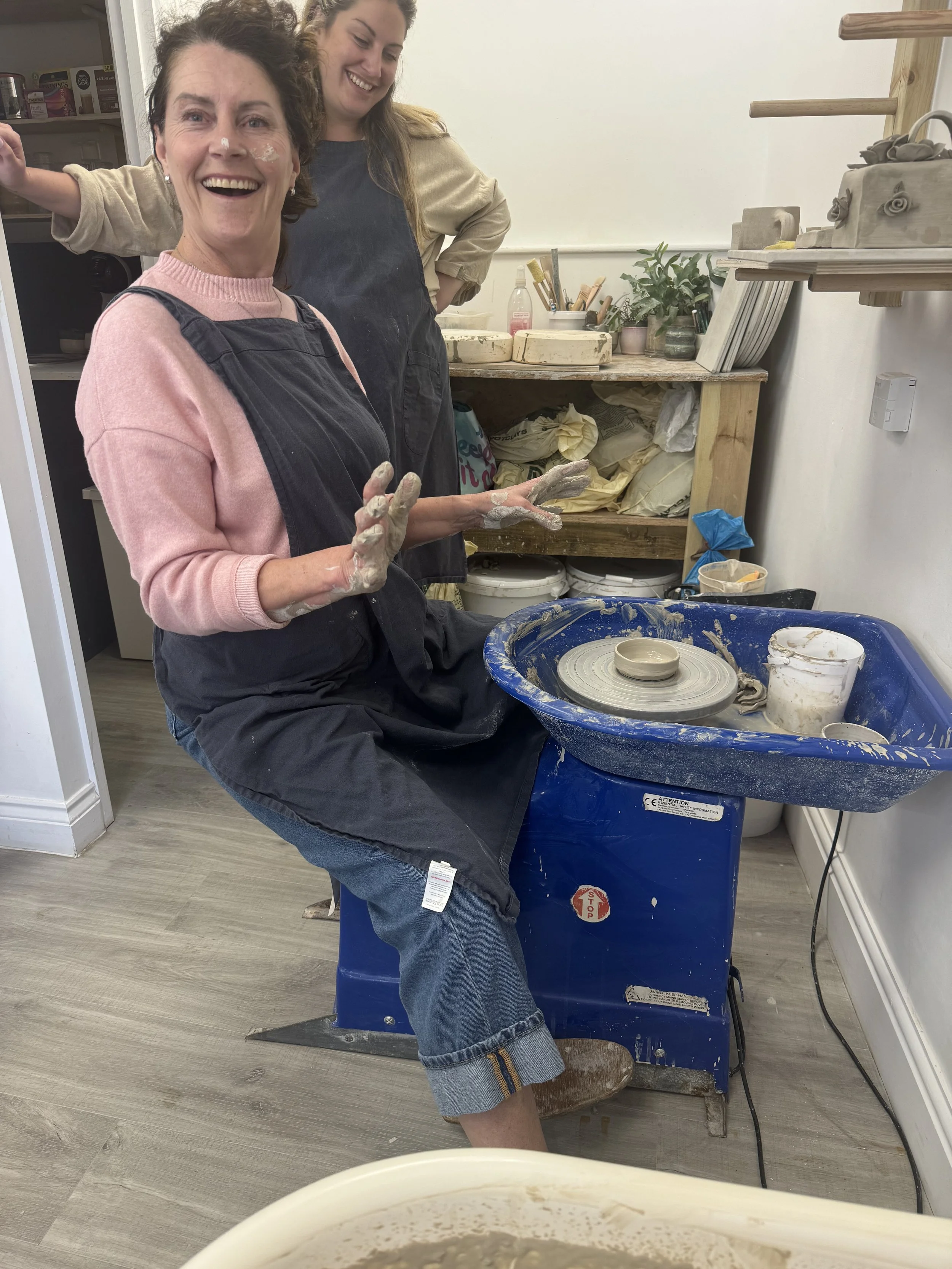 One person on Two-Hour Taster session, messy and smiling Participant with clay on her face smiling at the camera during a messy Two-Hour Throwing Taster session at Clod Pots.