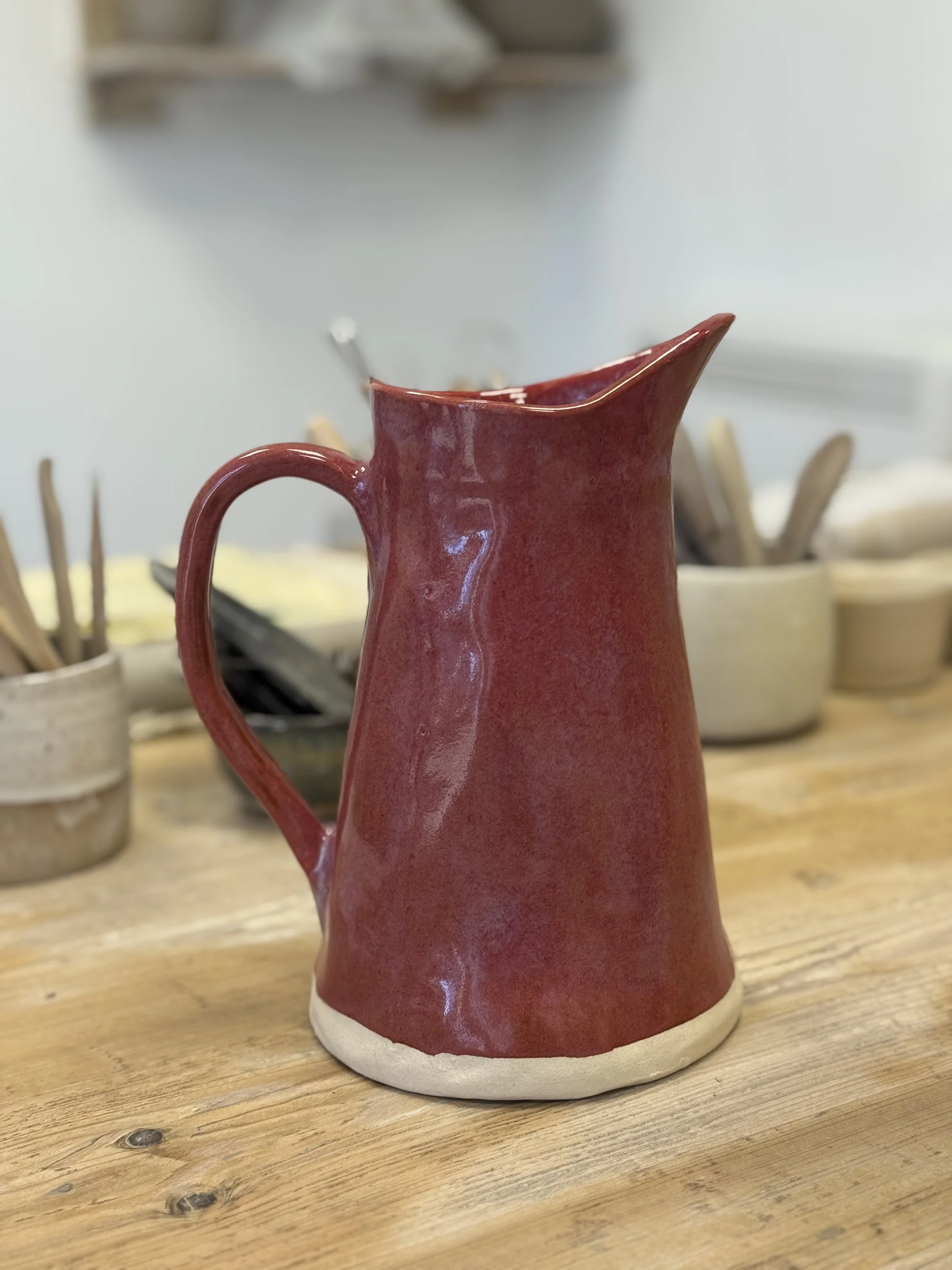 Jug Handmade ceramic jug displayed on a studio table at Clod Pots.. Made on the 7 Week Handbuilding Course