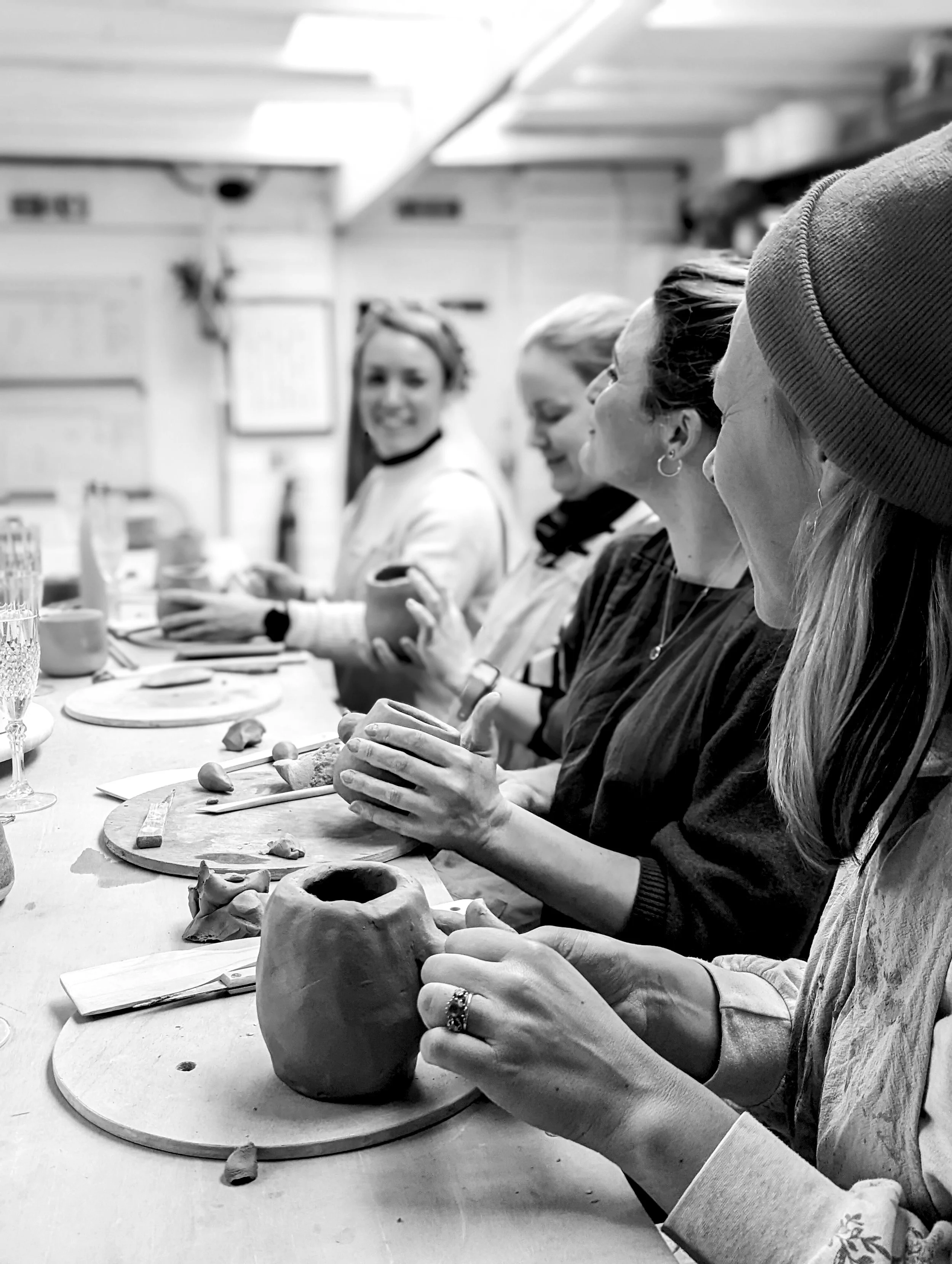 lose-up of hands shaping clay during a hen party pottery session