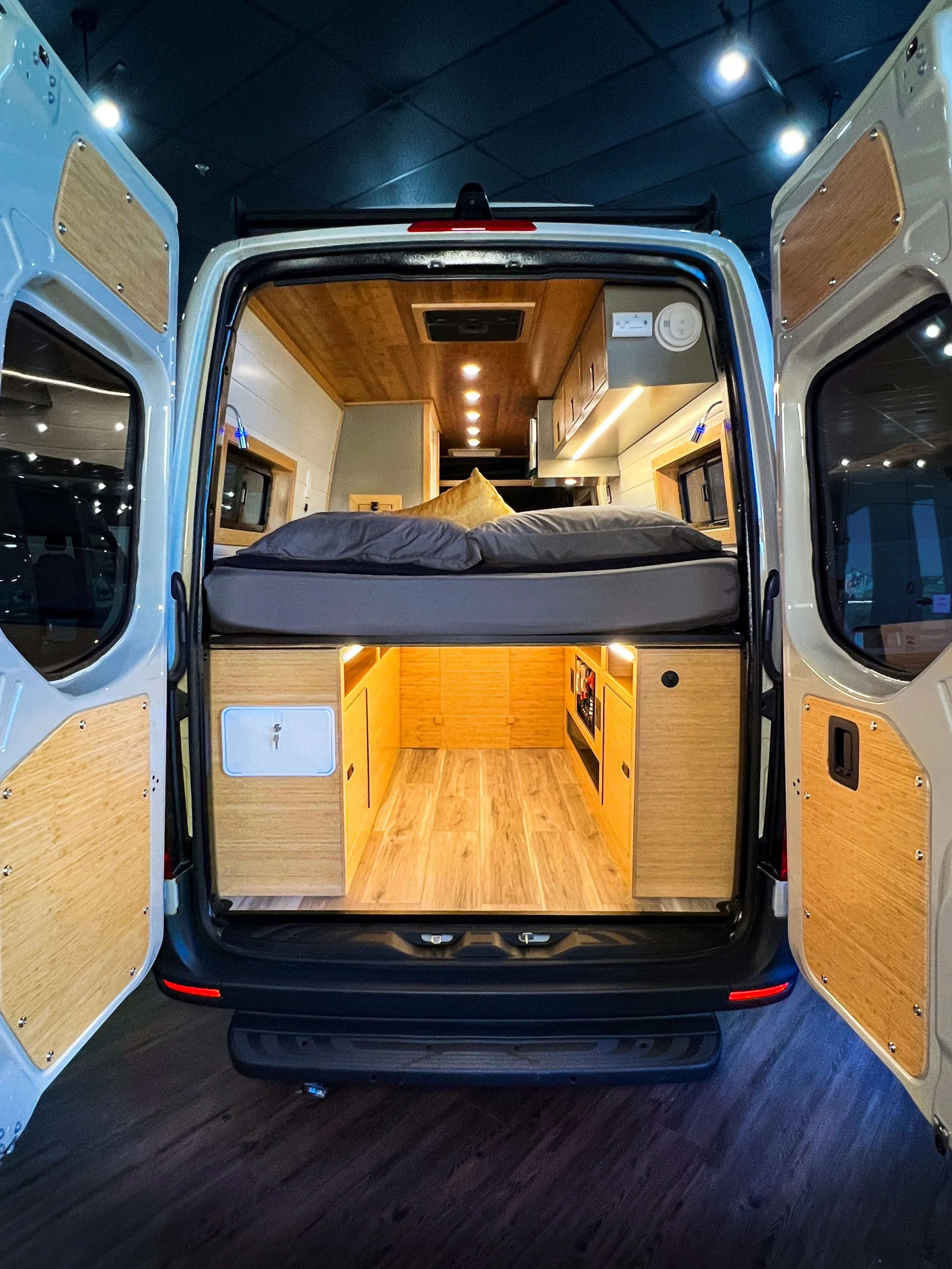 The Cascade rental campervan features a HUGE garage for storage, ready to house your bulkiest of items! The electrical and plumbing are tucking into the wheel well boxes of this space.