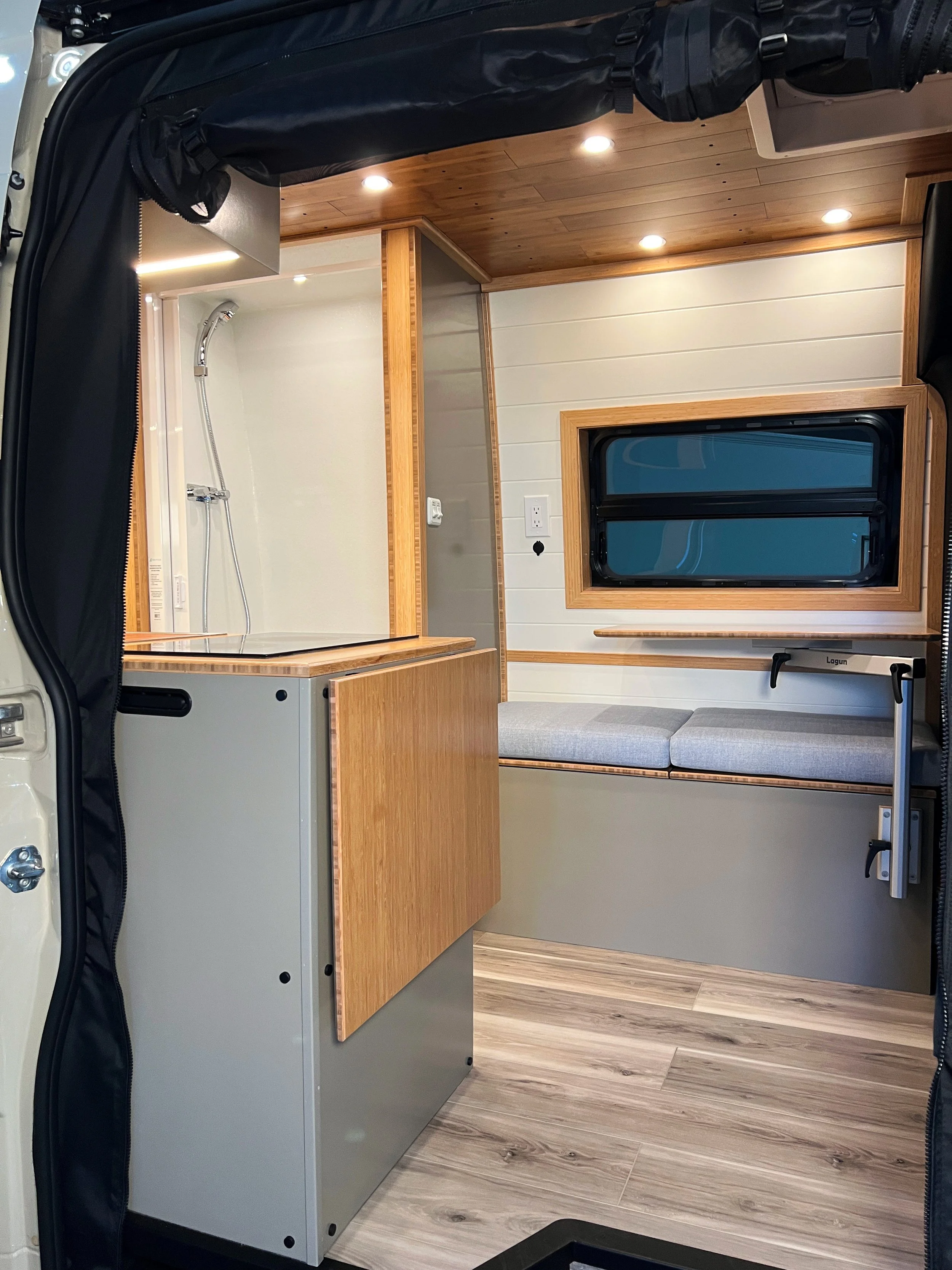 Looking in the Cascade rental, you see grey cabinetry, white walls, bamboo trim, indoor shower, Banff grey LVP flooring
