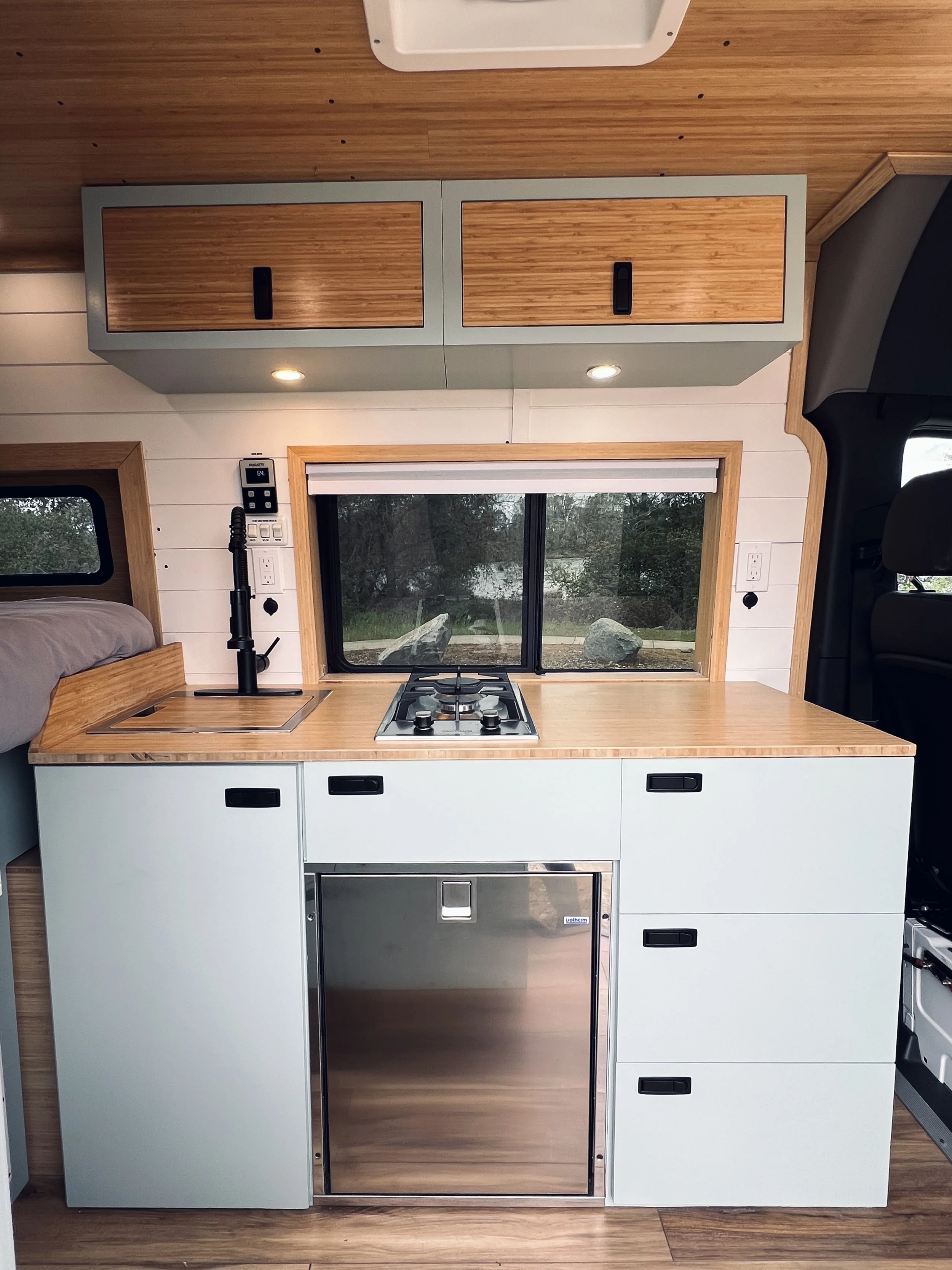 Fully equipped kitchen in The Aspen campervan rental, utensils provided
