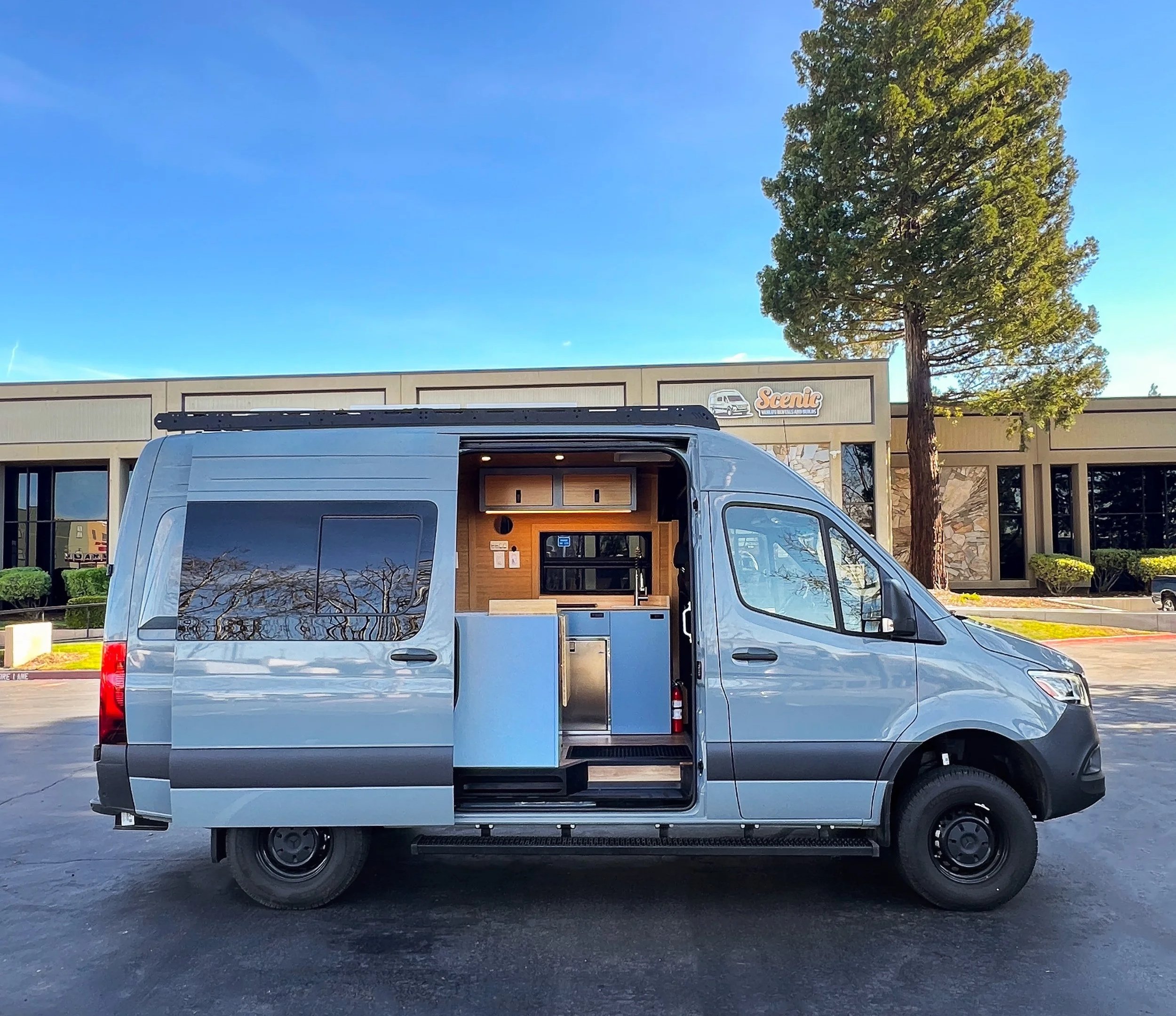 Exterior of Blue-Gray 144" Short wheelbase Mercedes Sprinter campervan with blue cabinetry inside