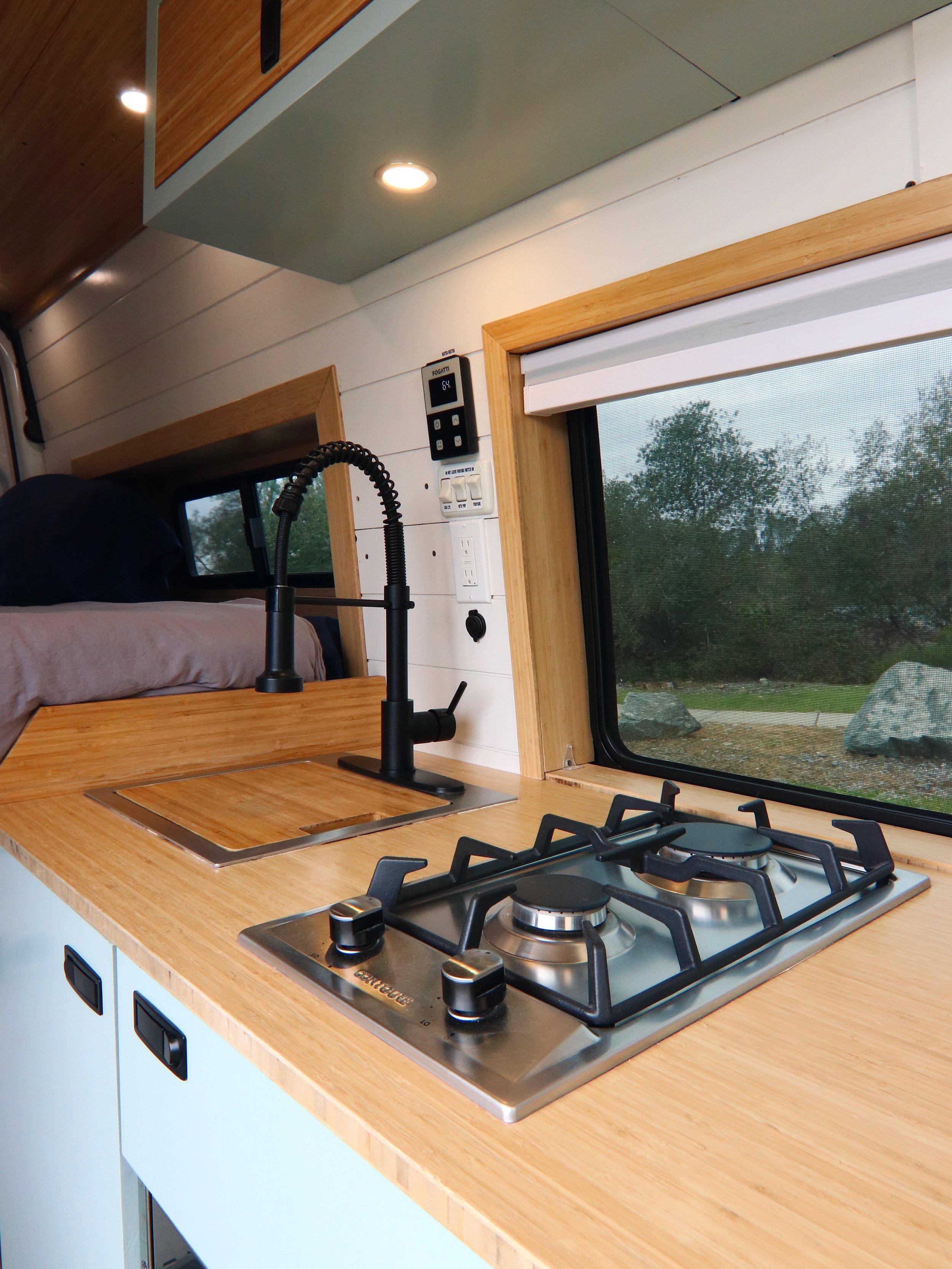 Sink and propane stovetop in campervan