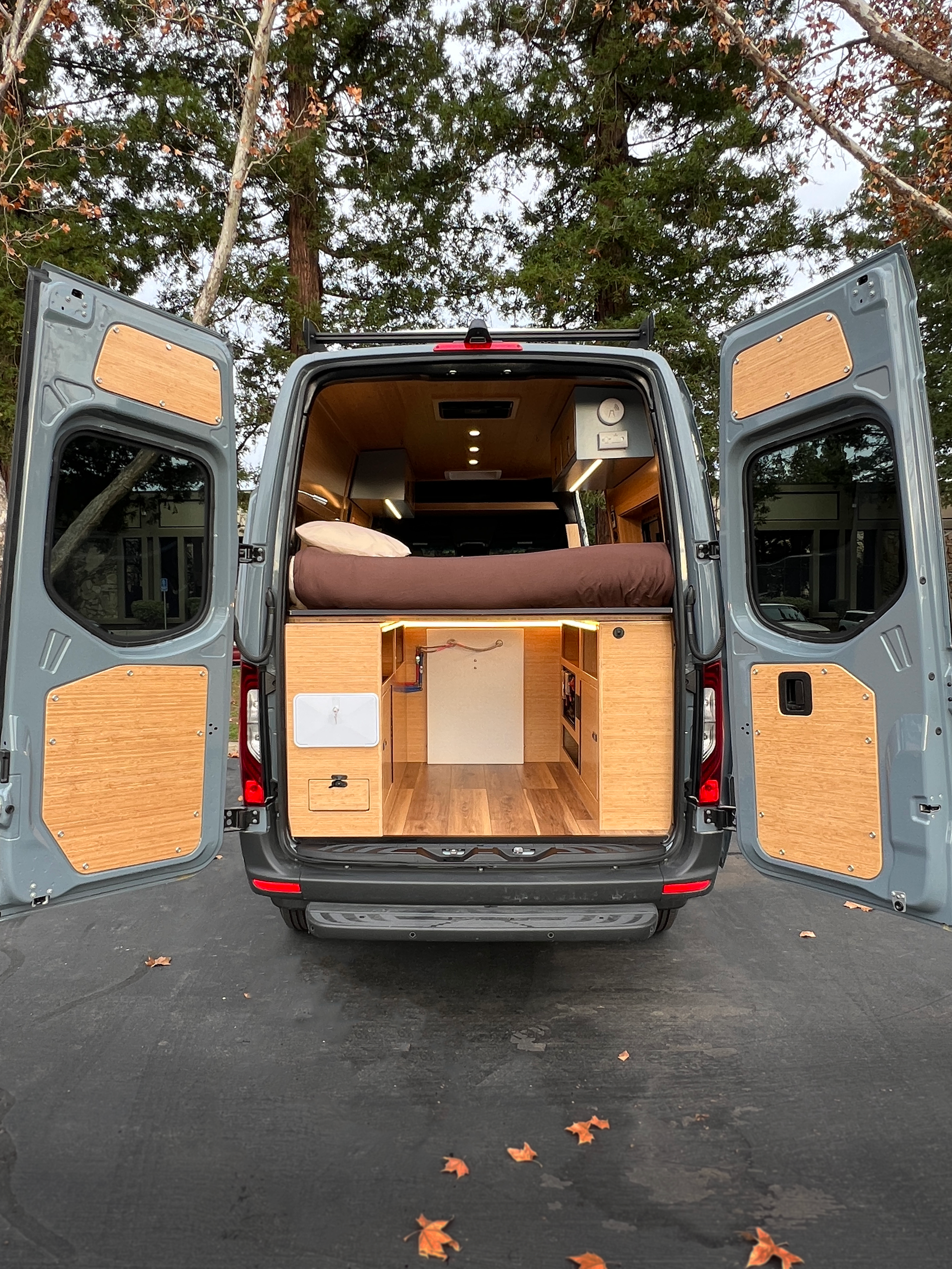 Back of campervan rental showing large garage and outdoor shower