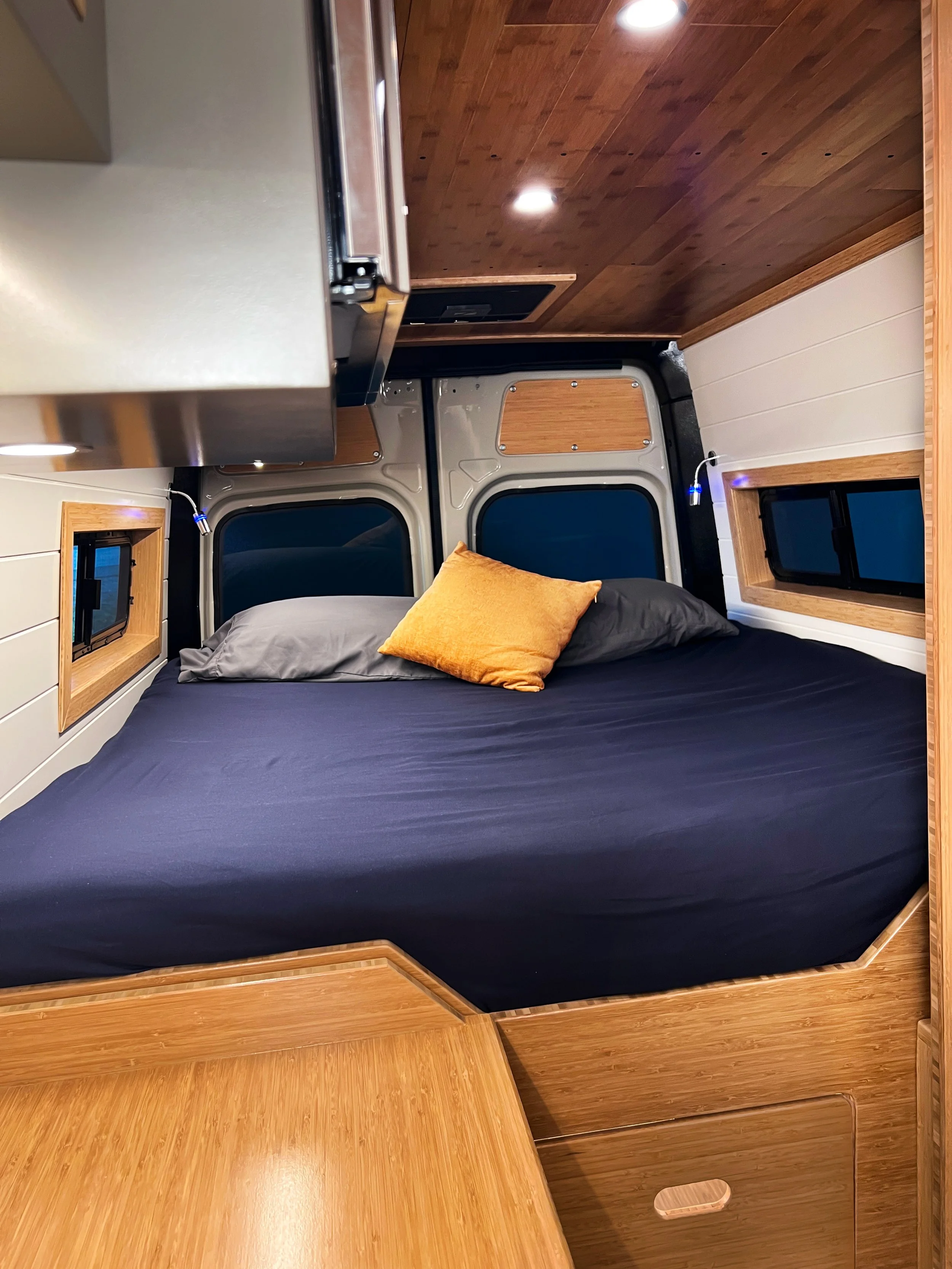 The near-king bed is custom-fit to this van and very comfortable - customer tried and tested!