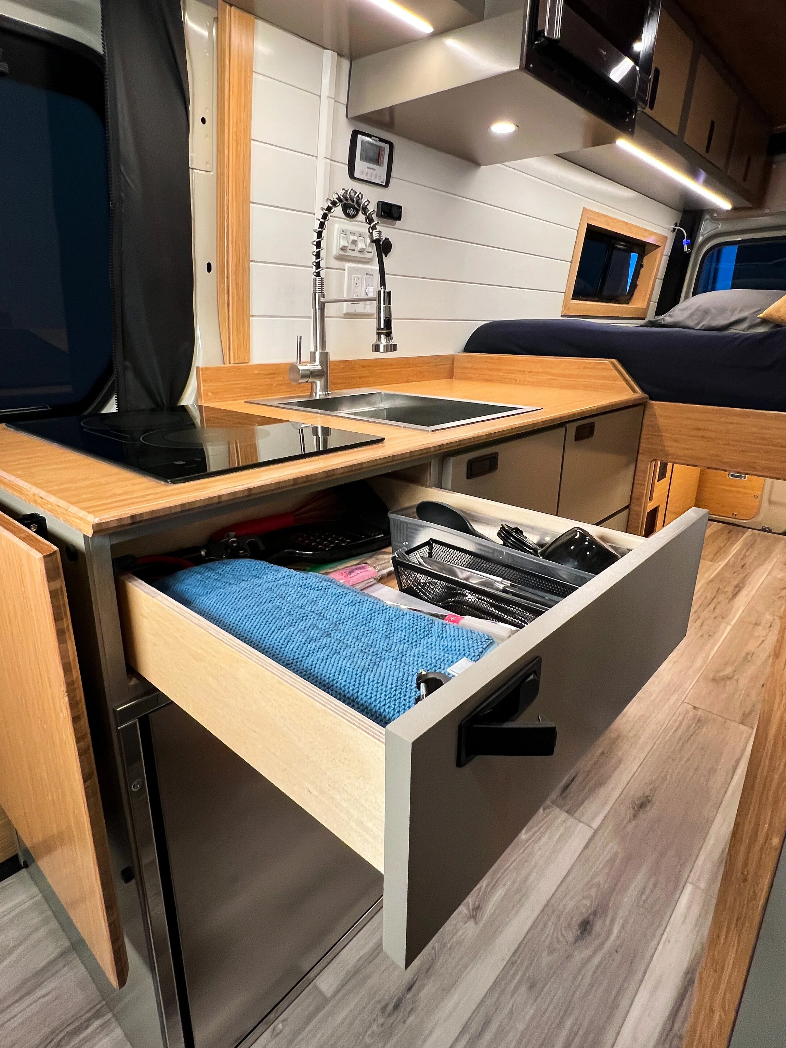 Scenic Vans provides the silverware you need, stored in a drawer above the fridge