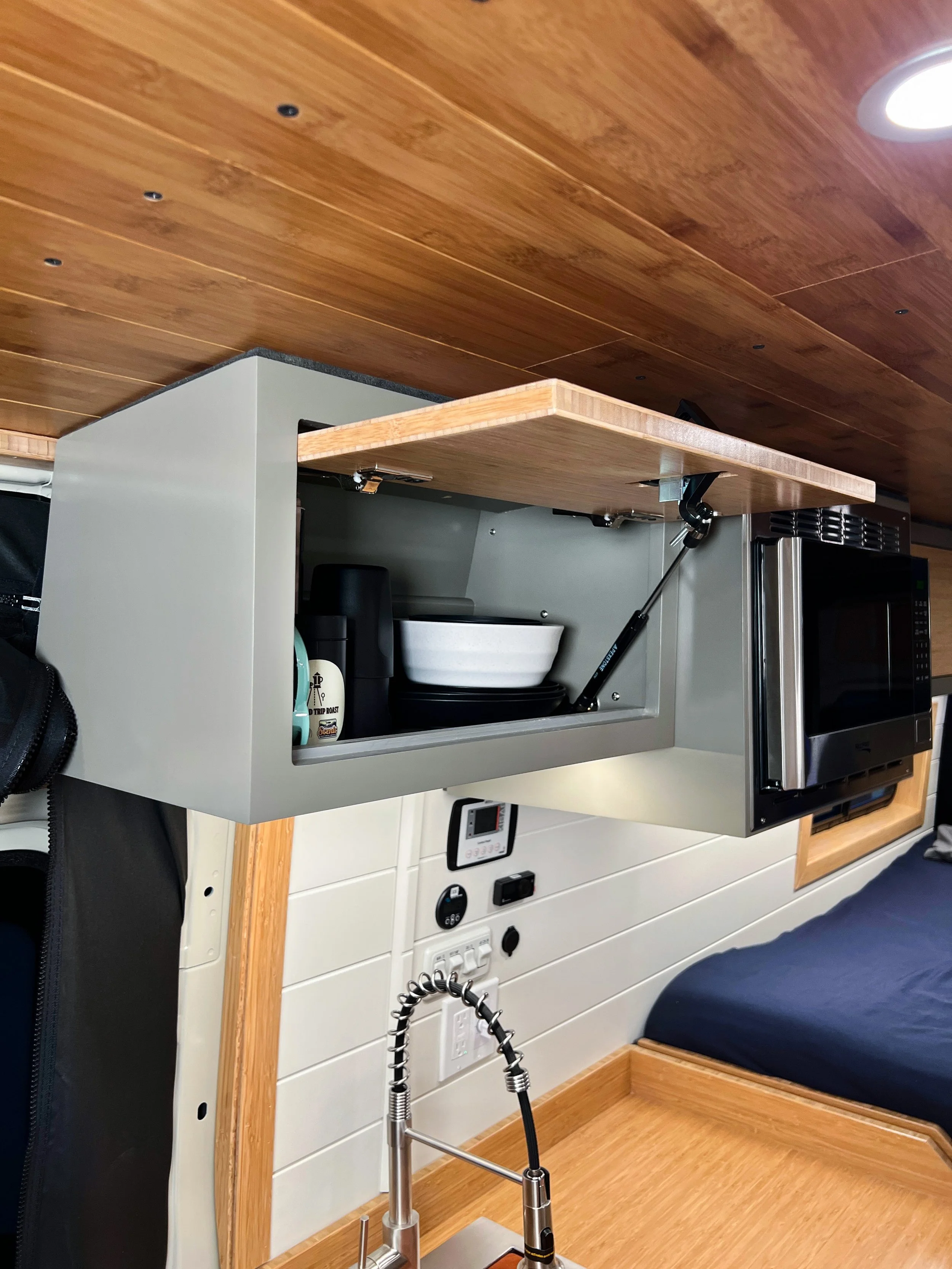 The overhead cabinets contain many of the Scenic-provided necessities for your trip, with 2 extra cabinets that are left empty for any additional supplies you may need.