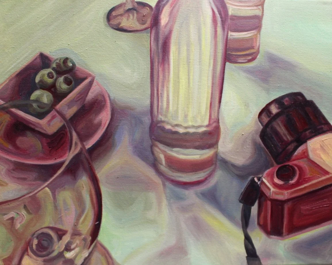 A painting of a still life scene with a glass of martini with olives, a striped bottle, a small jar, and a vintage red camera with a strap on a table with a light-colored cloth.