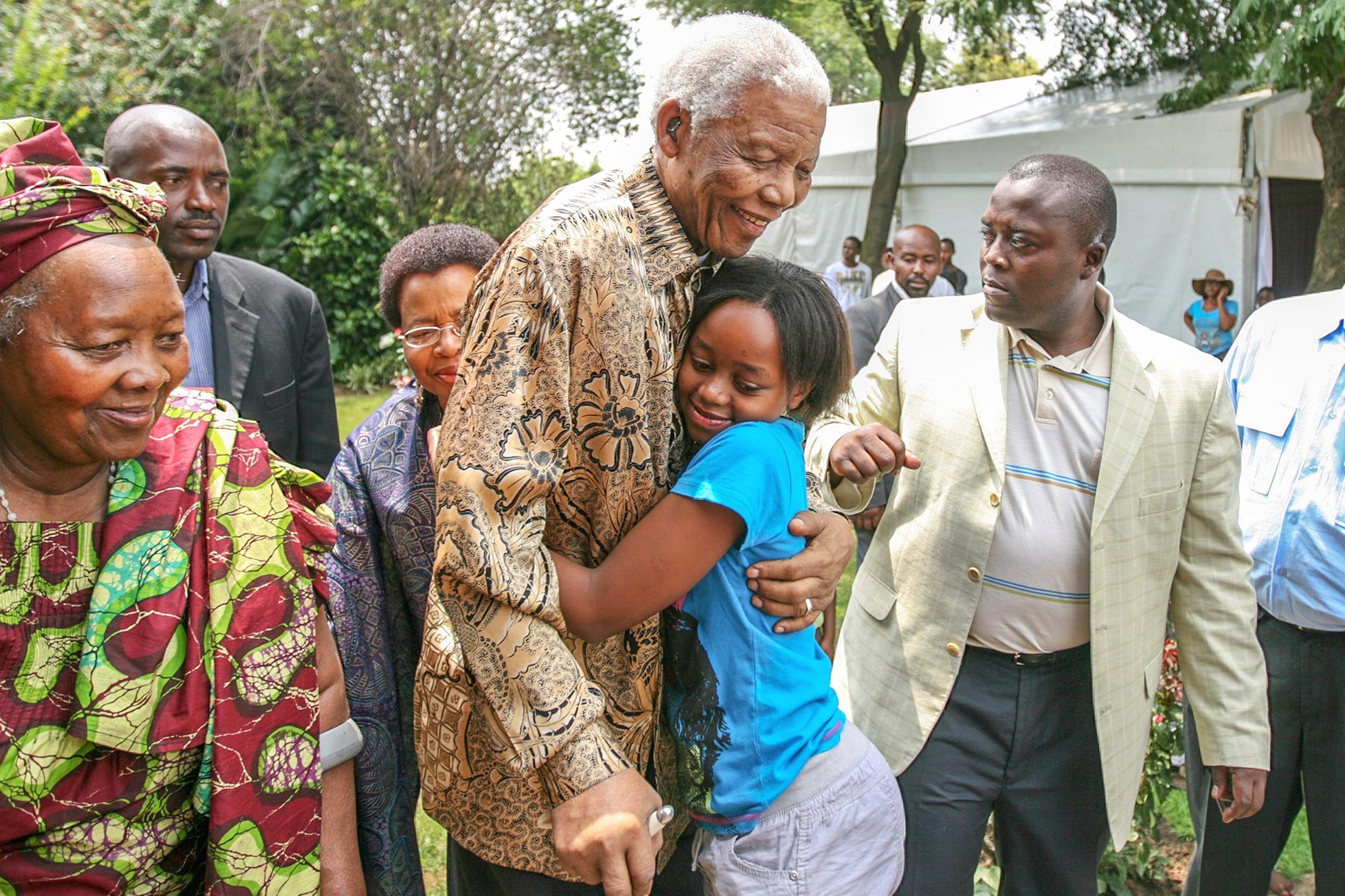 Former South African President, Nelson Mandela, hugs his great granddaughter at their family home in Soweto, South Africa. December 2008.