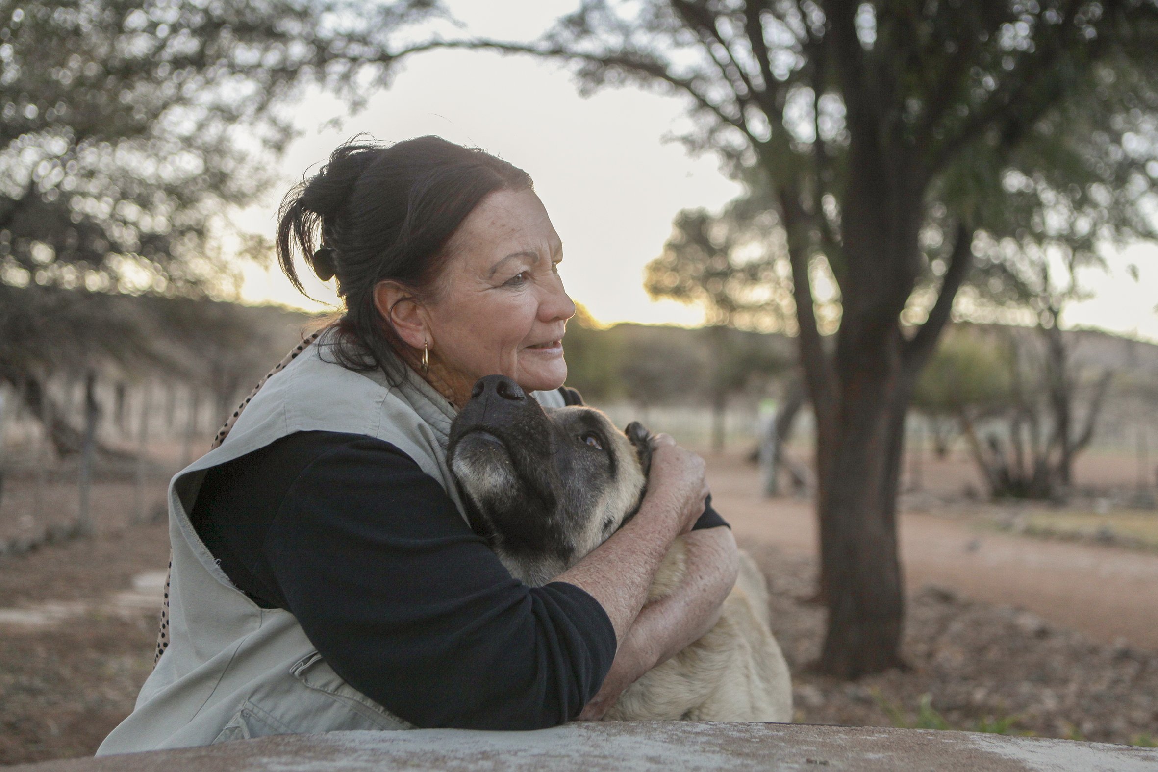 Farm owner Ritha Joubert hugs Anatolian Bonzo on Joubert's farm near Dordabis in Central Namibia. LGDs have reduced livestock losses for 91% of farmers involved in the programme.