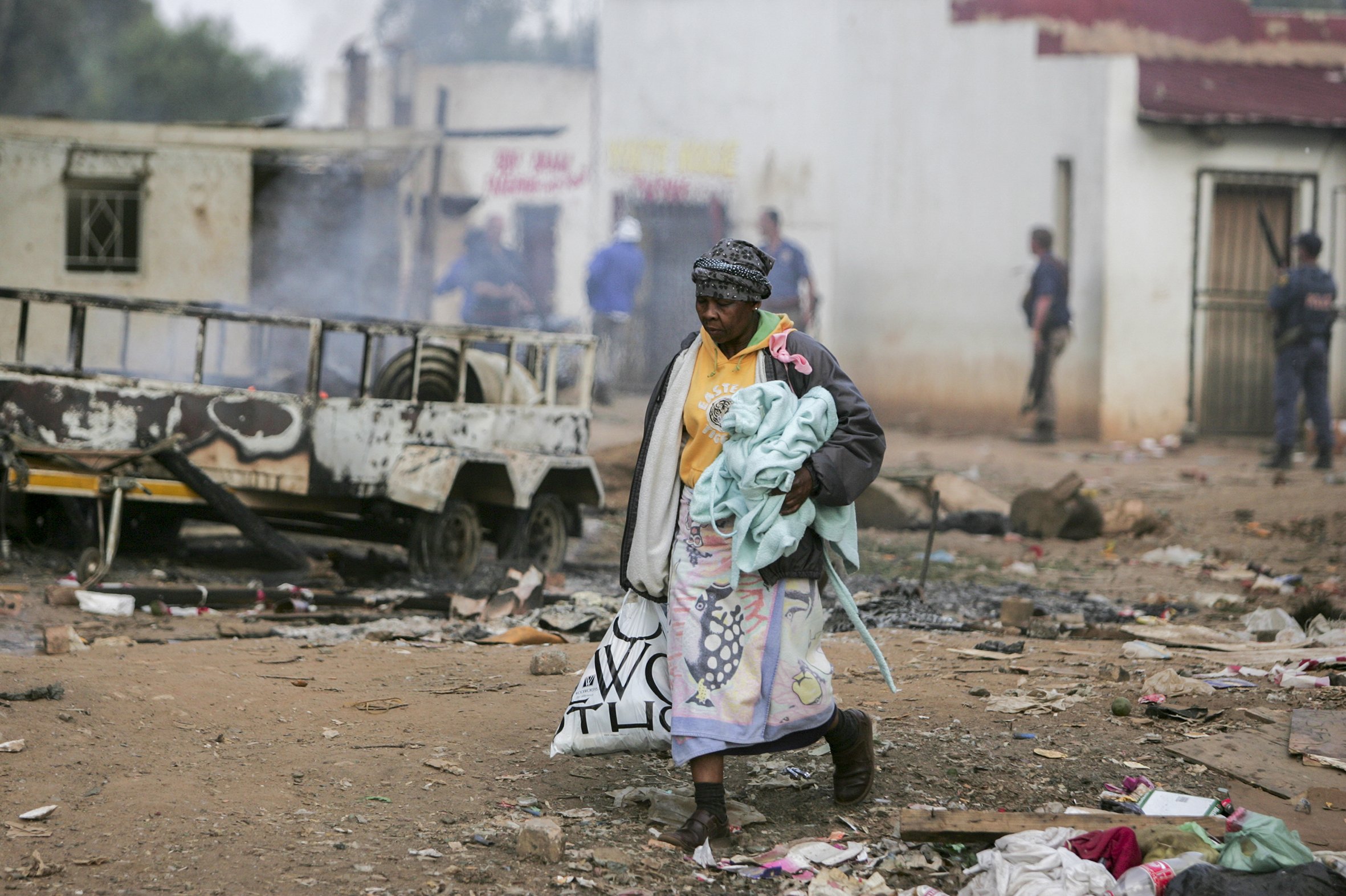 Foreigners escape with salvaged belongings during clashes between the police, foreigners and local residents. Makausi, Primrose, east of Johannesburg, South Africa.