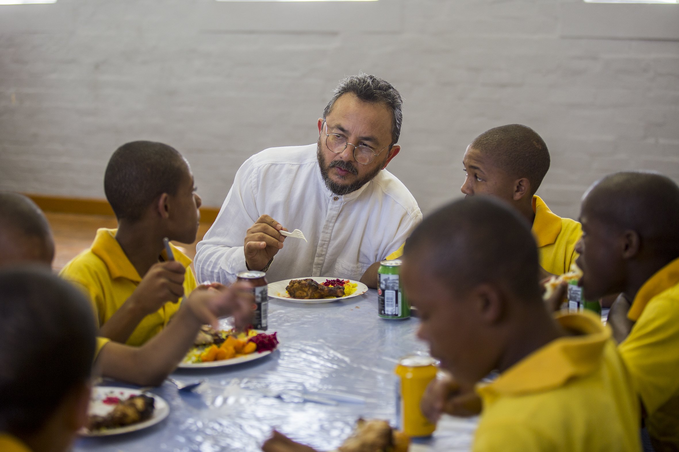 Moosa Mohadick eats Sunday lunch with his students at the Ottery Youth Care Centre. April 2017.