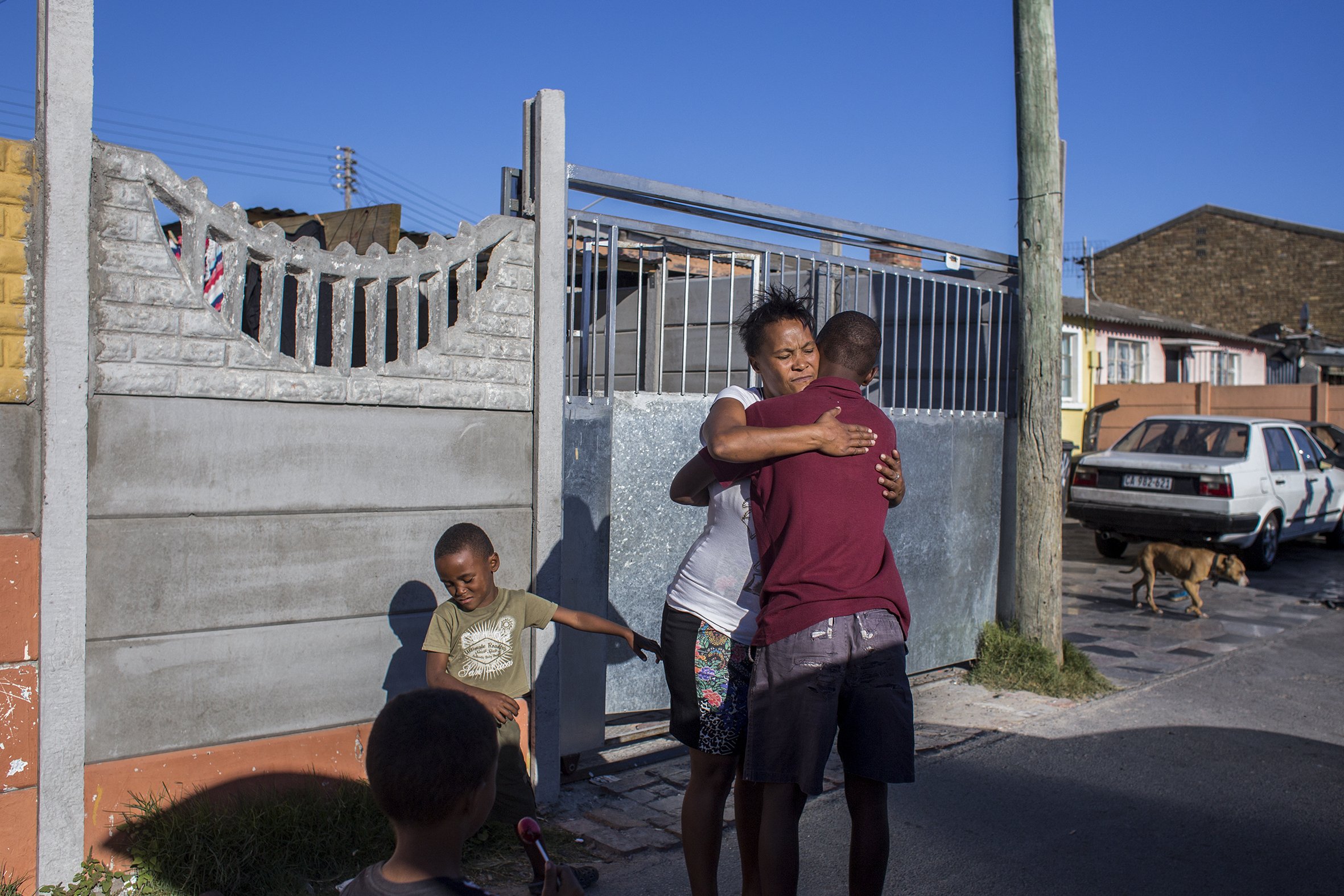 A mother of one of the students at the Ottery Youth Care Centre says goodbye to her son as he returns to the Centre. April 2017.